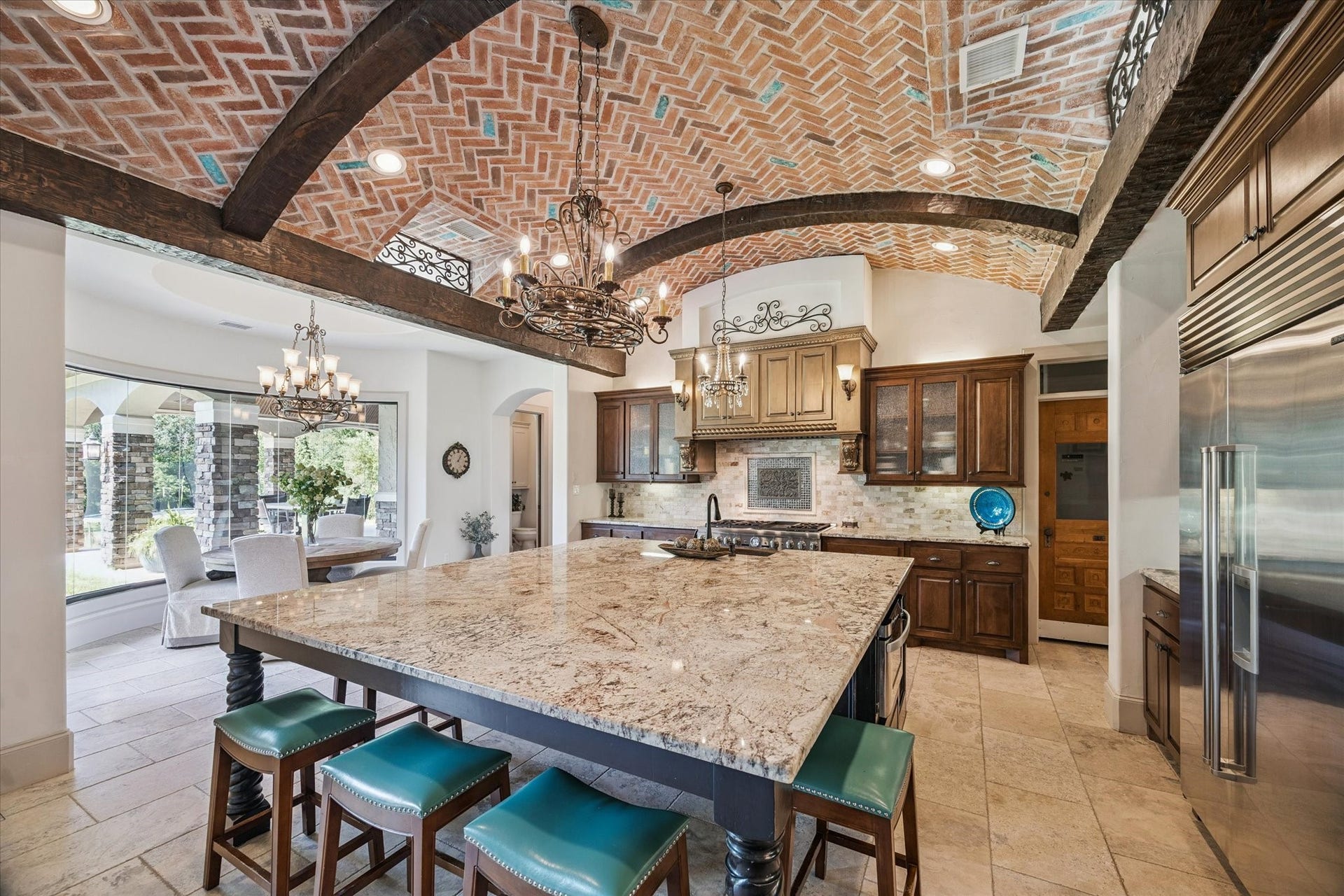 Gourmet kitchen perfect with large walk-in pantry for entertaining with spacious granite island and countertops, Thermador double ovens, and Sub-Zero refrigerator and freezer