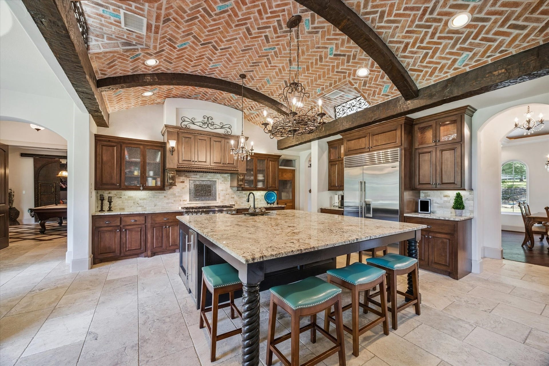 Gourmet kitchen perfect with large walk-in pantry for entertaining with spacious granite island and countertops, Thermador double ovens, and Sub-Zero refrigerator and freezer