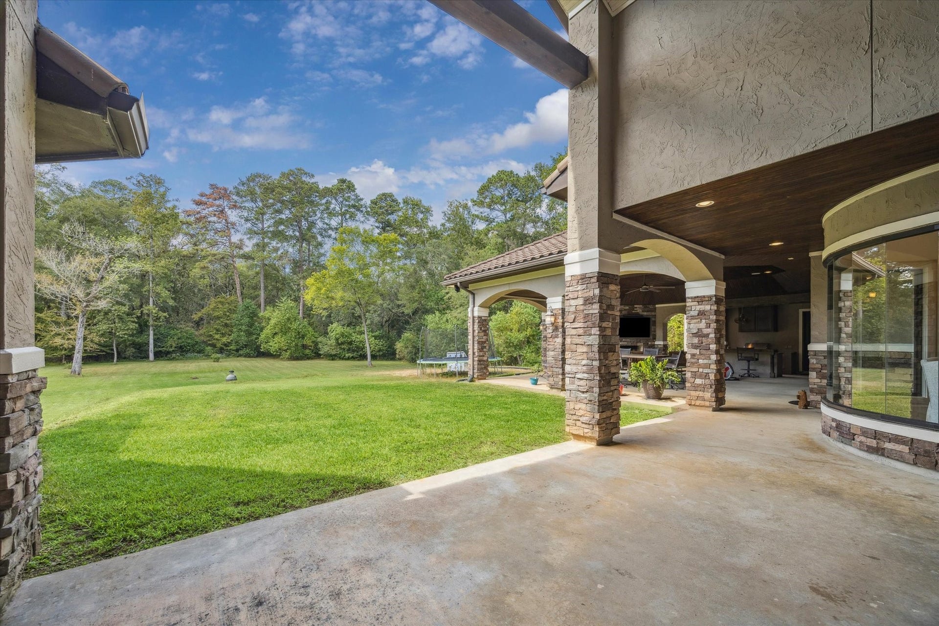 Stunning outdoor covered patio with fireplace and outdoor kitchen - perfect for entertaining!