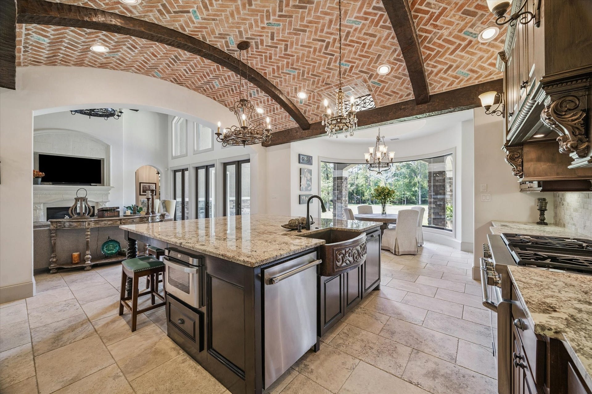 Gourmet kitchen perfect with large walk-in pantry for entertaining with spacious granite island and countertops, Thermador double ovens, and Sub-Zero refrigerator and freezer