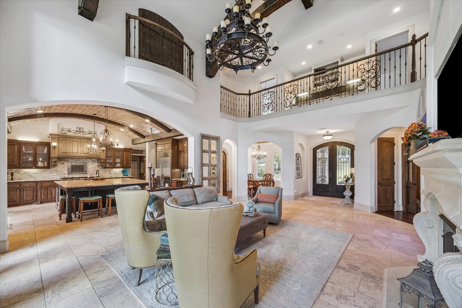 Gorgeous living room off of kitchen with gaslog fireplace, abundant natural light, and high ceilings