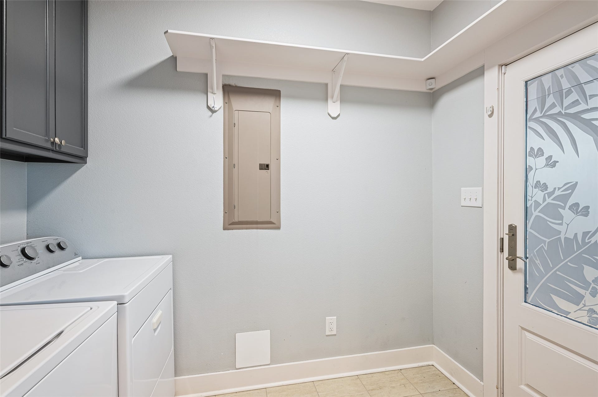 Utility room with door to deck on north side of house