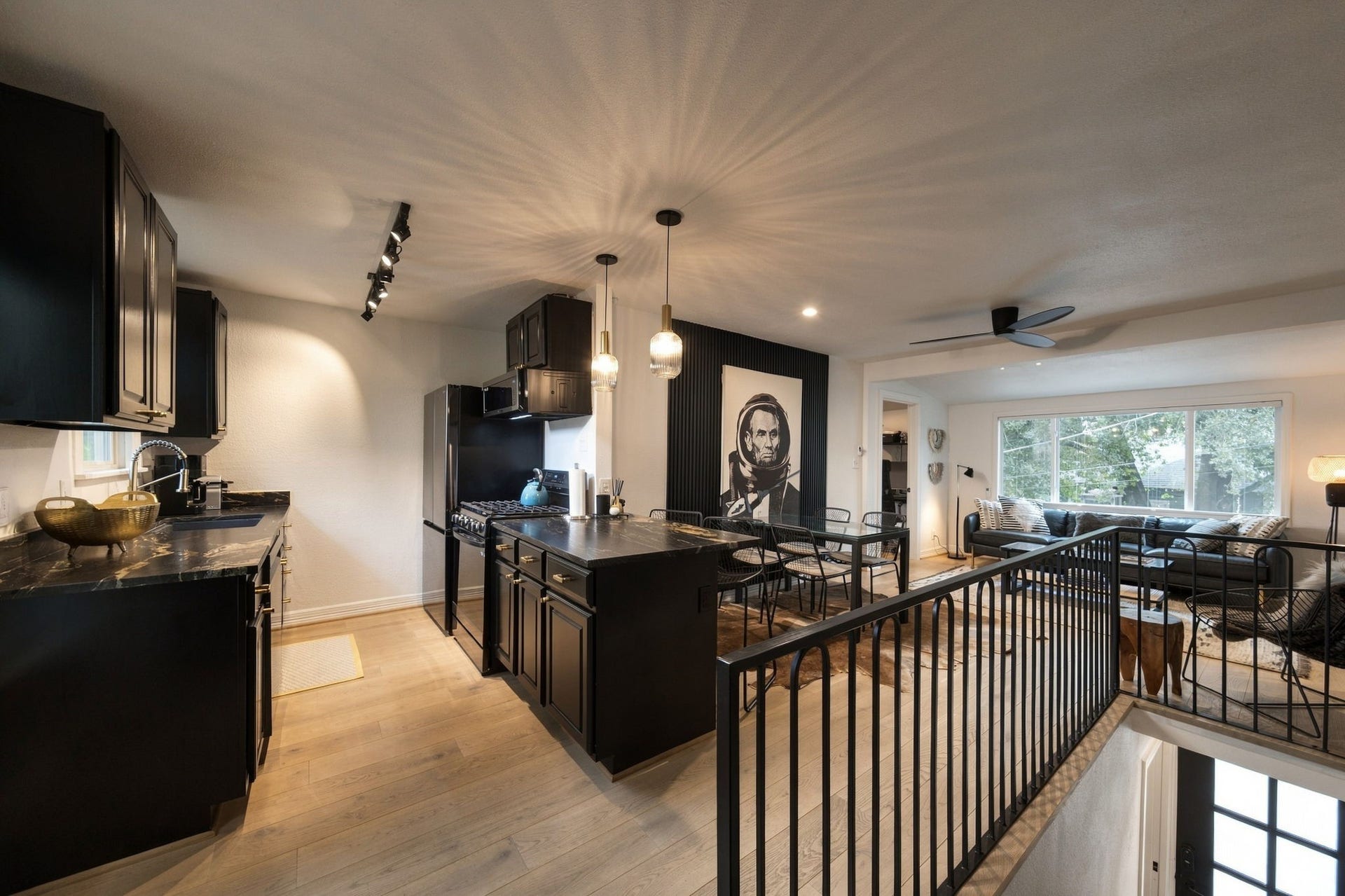 A view that shows the upstairs living area, dining room and kitchen.
