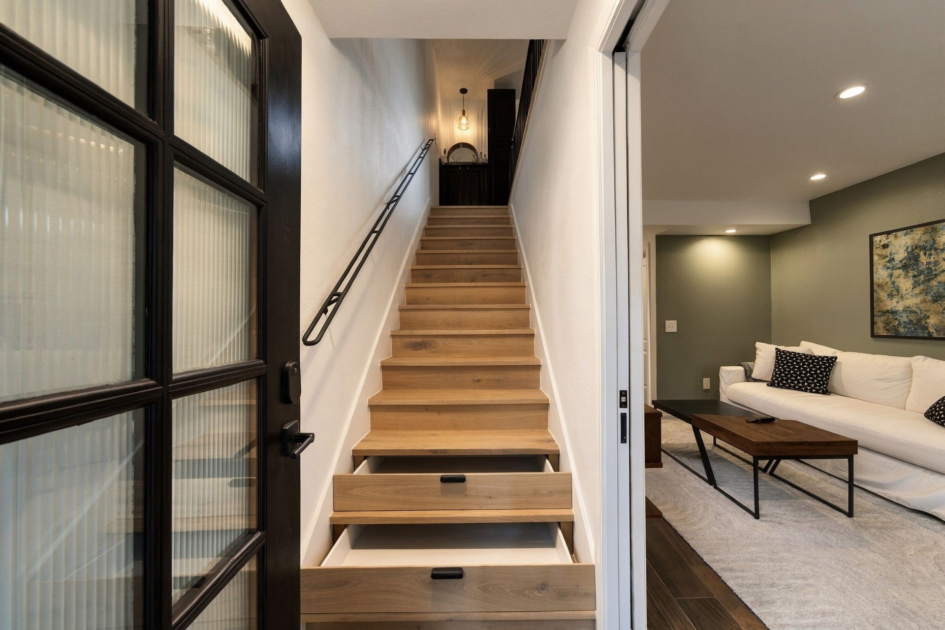 The entry with clever storage in the steps. To the right is one bedroom and bath.