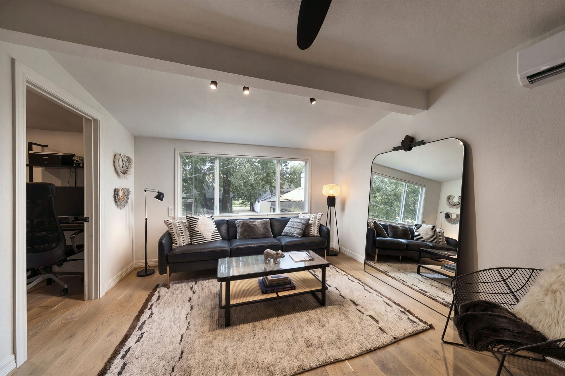 Living area with a large window overlooking the front of the house.