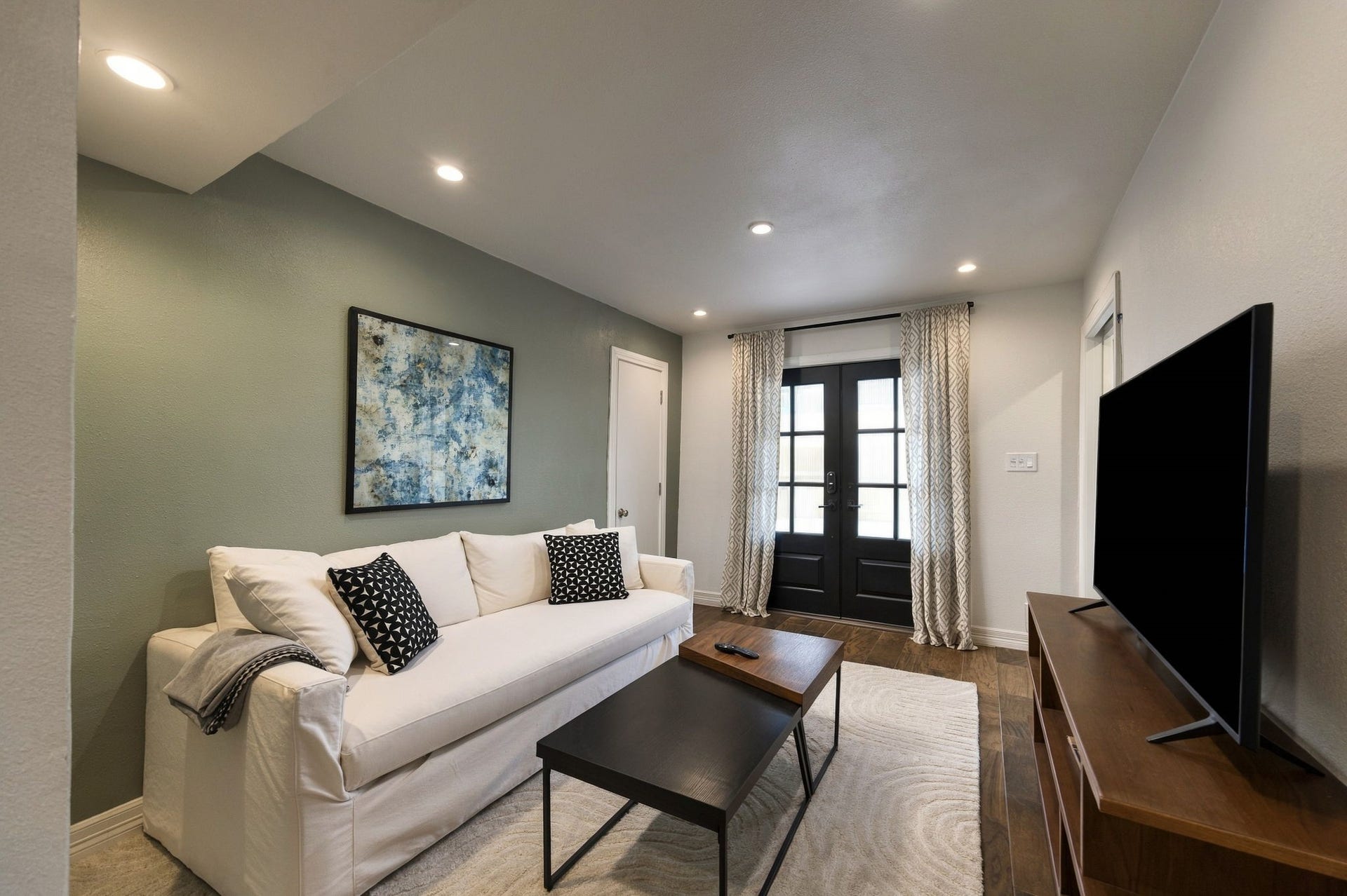 Downstairs is currently set up as a living area but has a door to close off from the stairs. With a full bath it is an ideal bedroom.