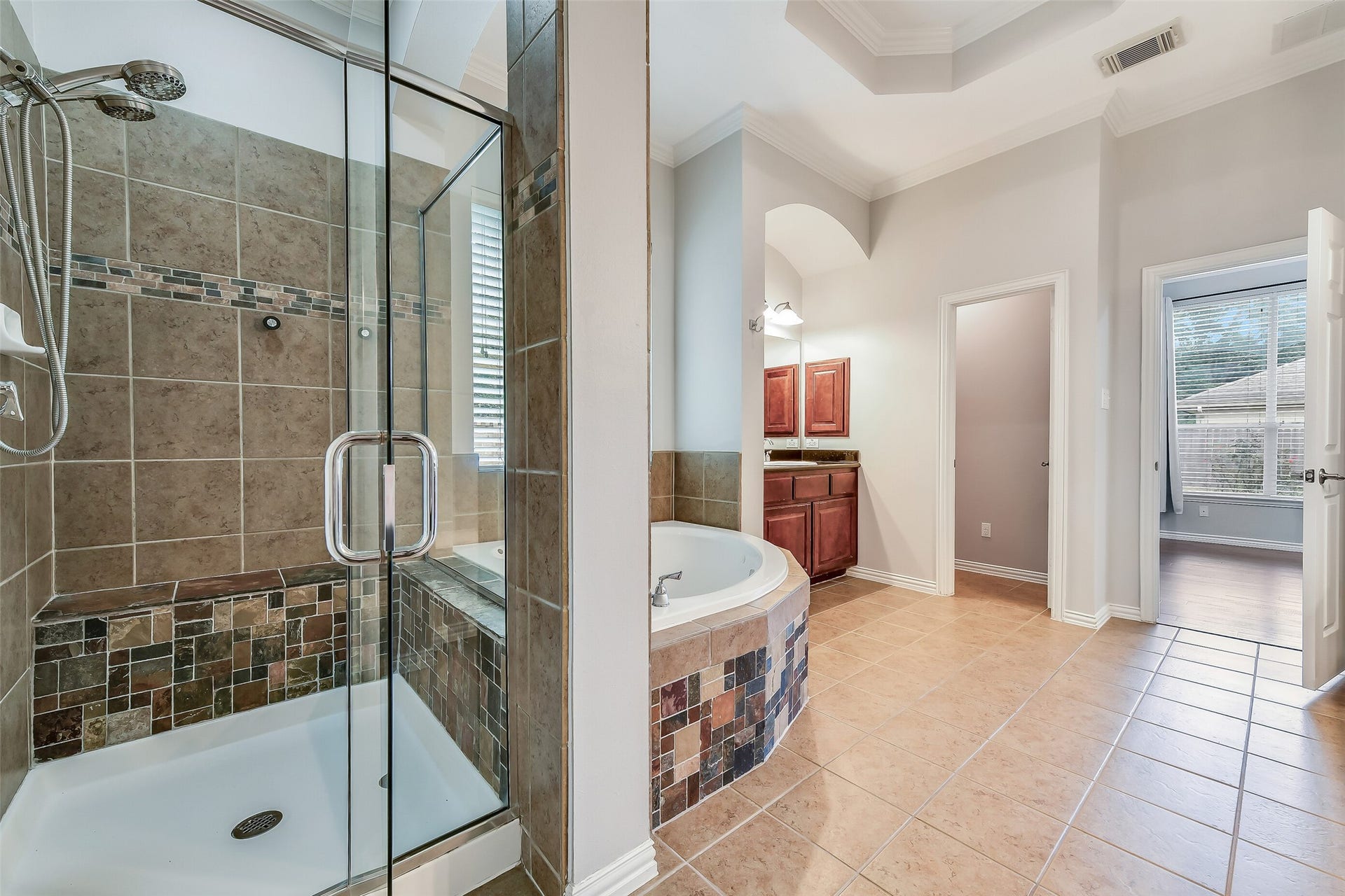 8407 Alyssa Gardens Lane, Humble, TX 77396 This view highlights the second sink and vanity area along with the dual showerheads in the walk-in shower.