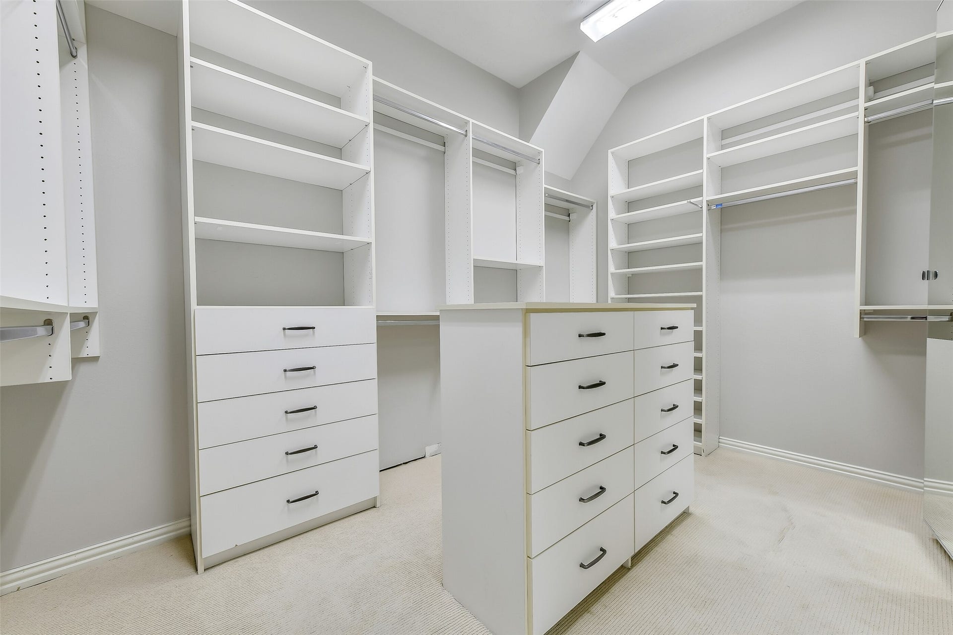 8407 Alyssa Gardens Lane, Humble, TX 77396 The oversized primary closet features custom California Closet upgrades with built-in storage and drawers, freeing up valuable floor space in the bedroom.