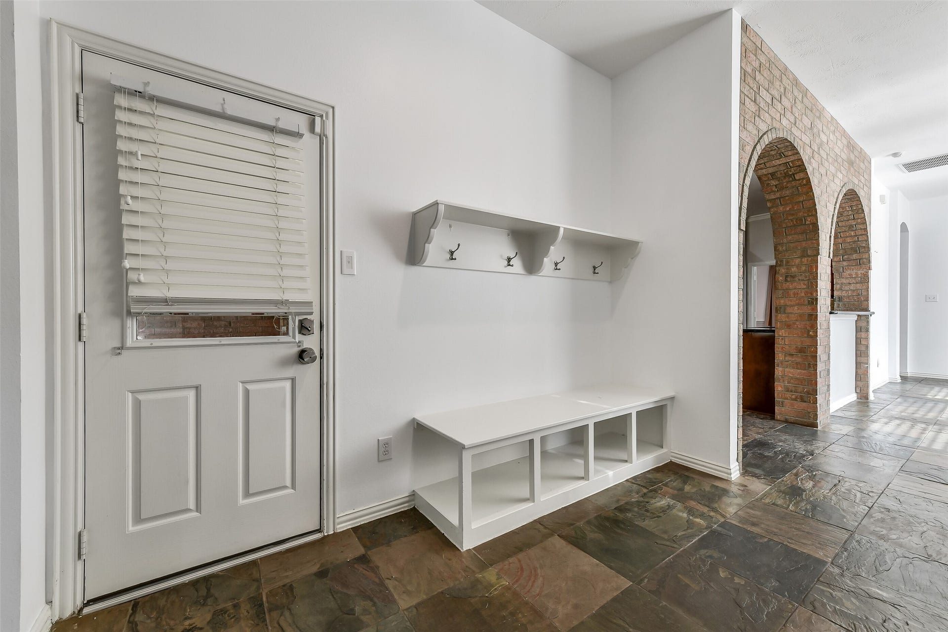8407 Alyssa Gardens Lane, Humble, TX 77396 Conveniently located off the driveway entrance, this functional mudroom offers the perfect space to organize jackets, backpacks, and sporting gear.