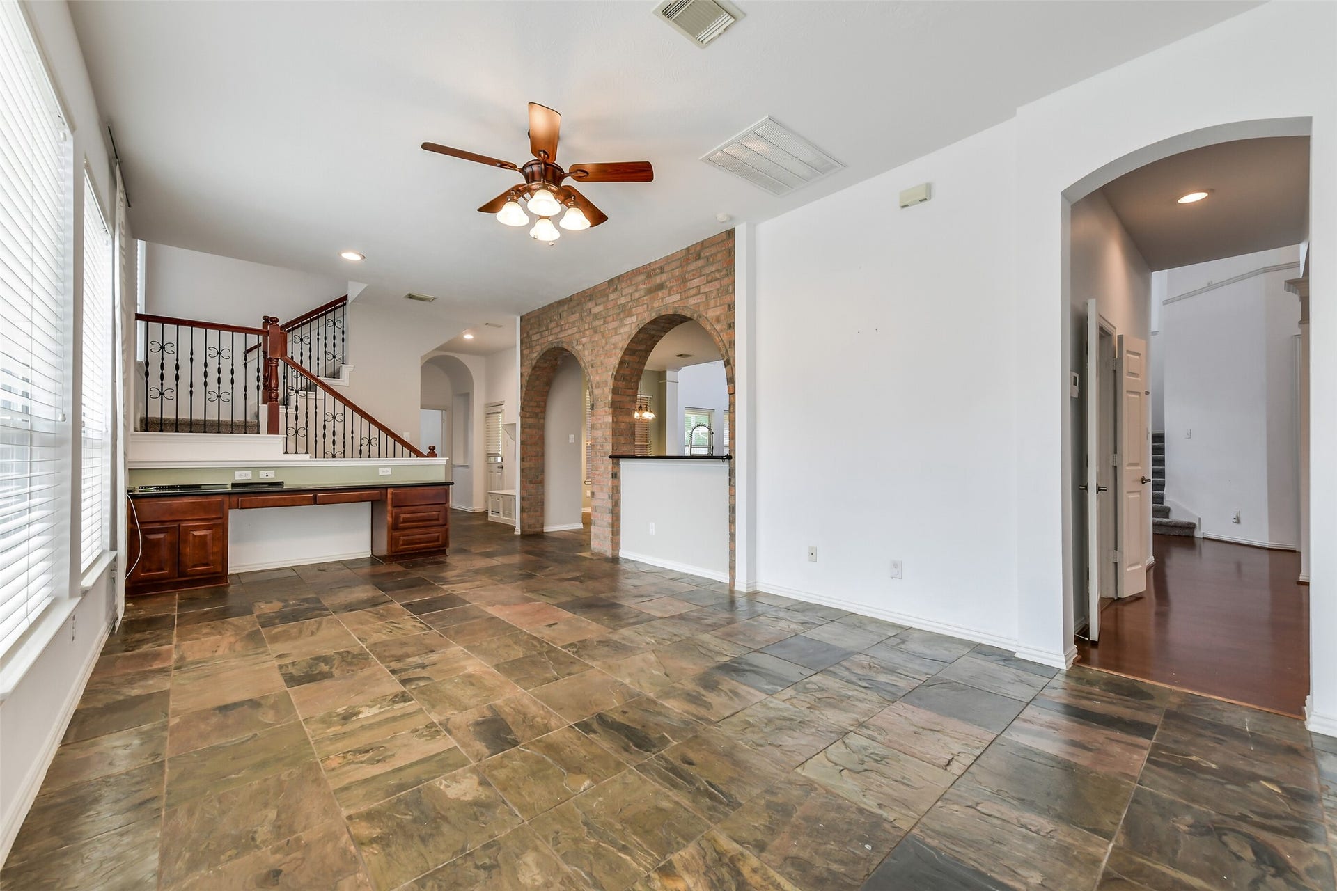 8407 Alyssa Gardens Lane, Humble, TX 77396 Flowing directly off the kitchen, this versatile sitting room/sunroom makes an exceptional first-floor entertaining spaceperfect for a pool table or shuffleboard along with custom built-in desk/bill pay station A second staircase provides convenient access to the upstairs landing and game room.