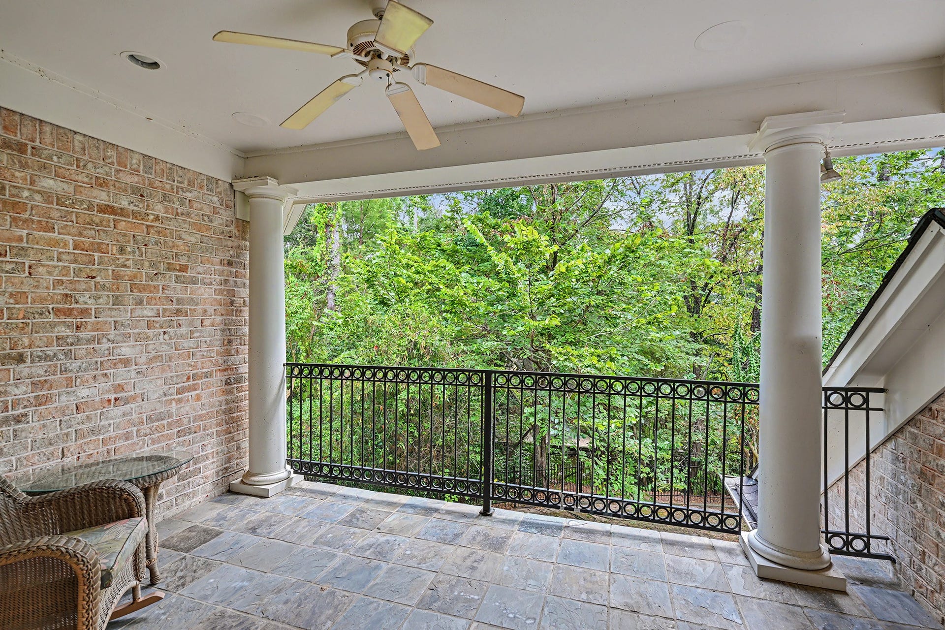 10 Sandalwood Drive, Houston, TX 77024 The upstairs covered patio is a wonderful spot to see nature and glimpses of the lakefront through the trees. Ready for morning coffee!