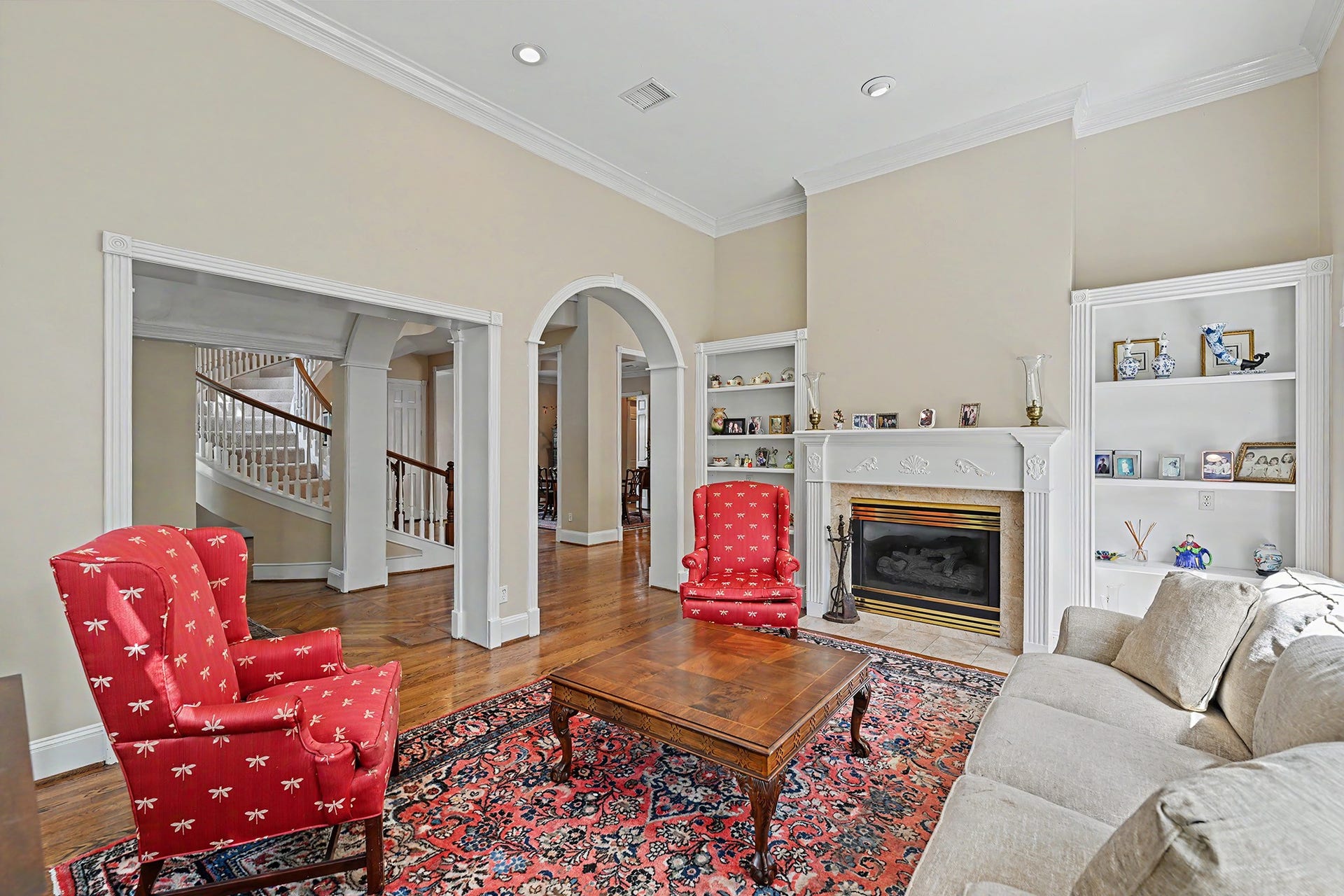 10 Sandalwood Drive, Houston, TX 77024 Formal living room's gaslog fireplace is flanked by custom built-in shelves.