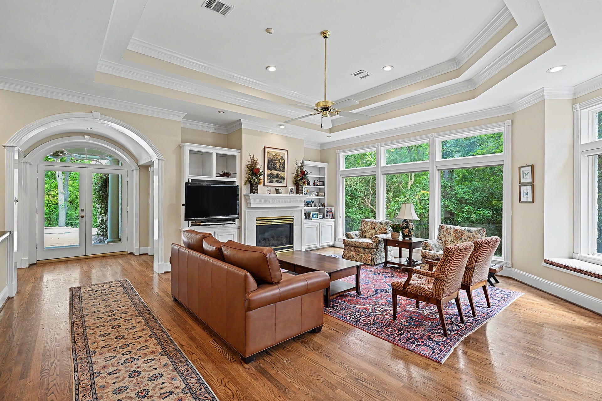 10 Sandalwood Drive, Houston, TX 77024 The family room feels like home with 11 ft trayed ceiling, floor to ceiling windows, and a fireplace with marble surround. The window seat is a favorite spot!