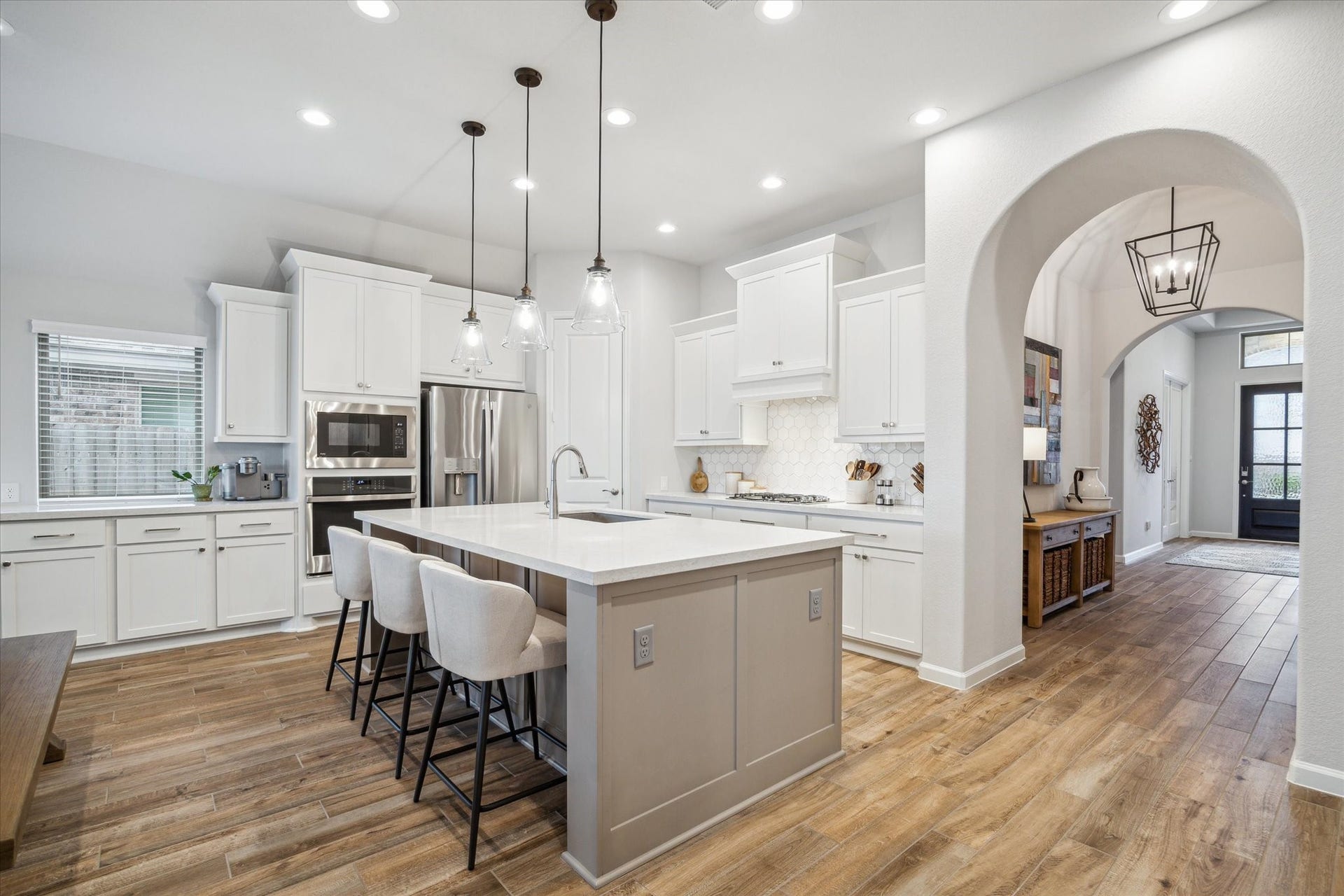 1523 Carson Field Lane, Richmond, TX 77469 A Chef's dream! This gourmet kitchen features quartz countertops with a neutral backsplash, an oversized island perfect for entertaining, stainless steel appliances, tons of counterspace & cabinetry. Fridge STAYS!