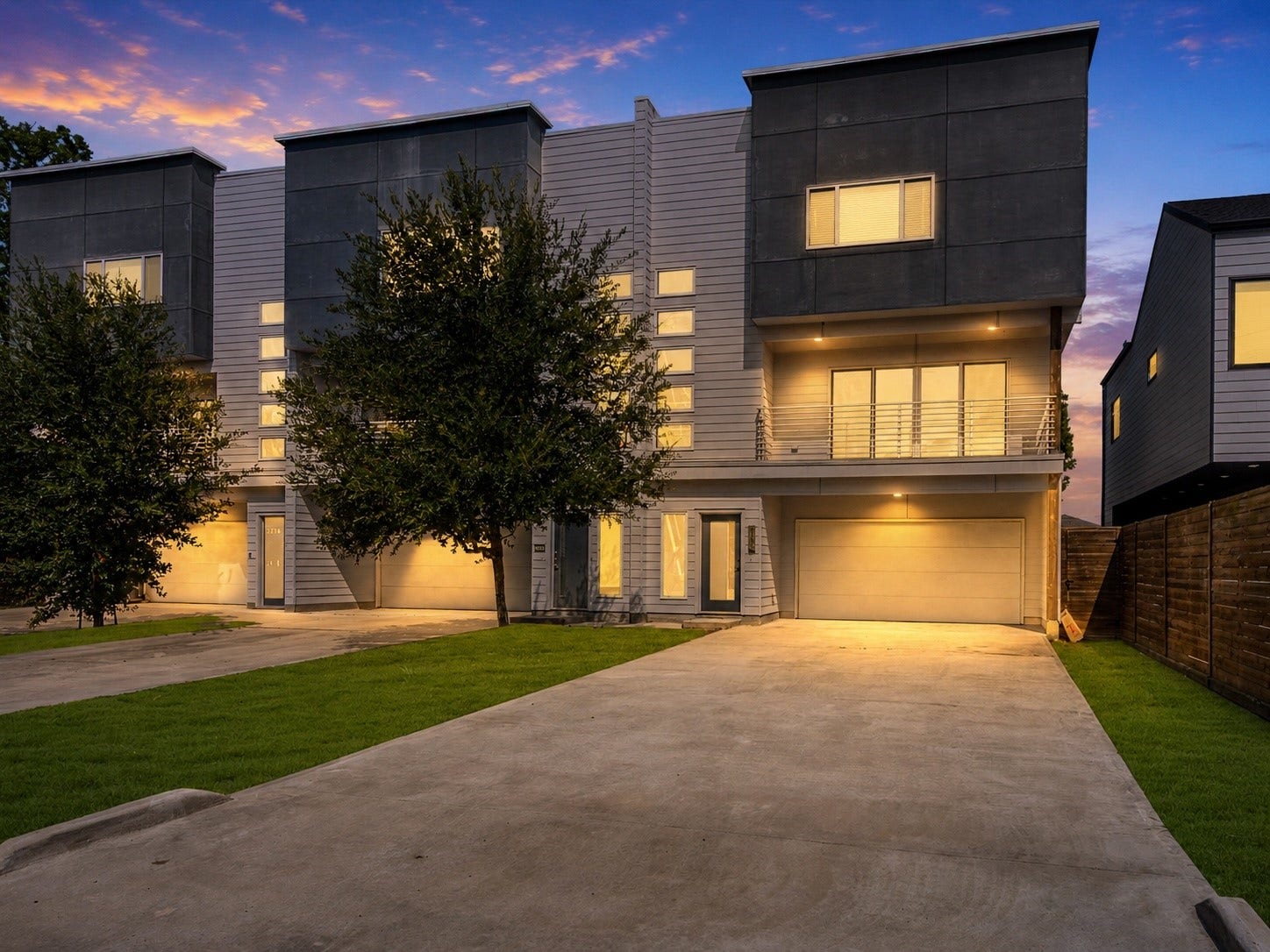 219 Pheasant Street, #C, Houston, TX 77018 Modern townhouse with a sleek exterior, large windows, and a spacious driveway.