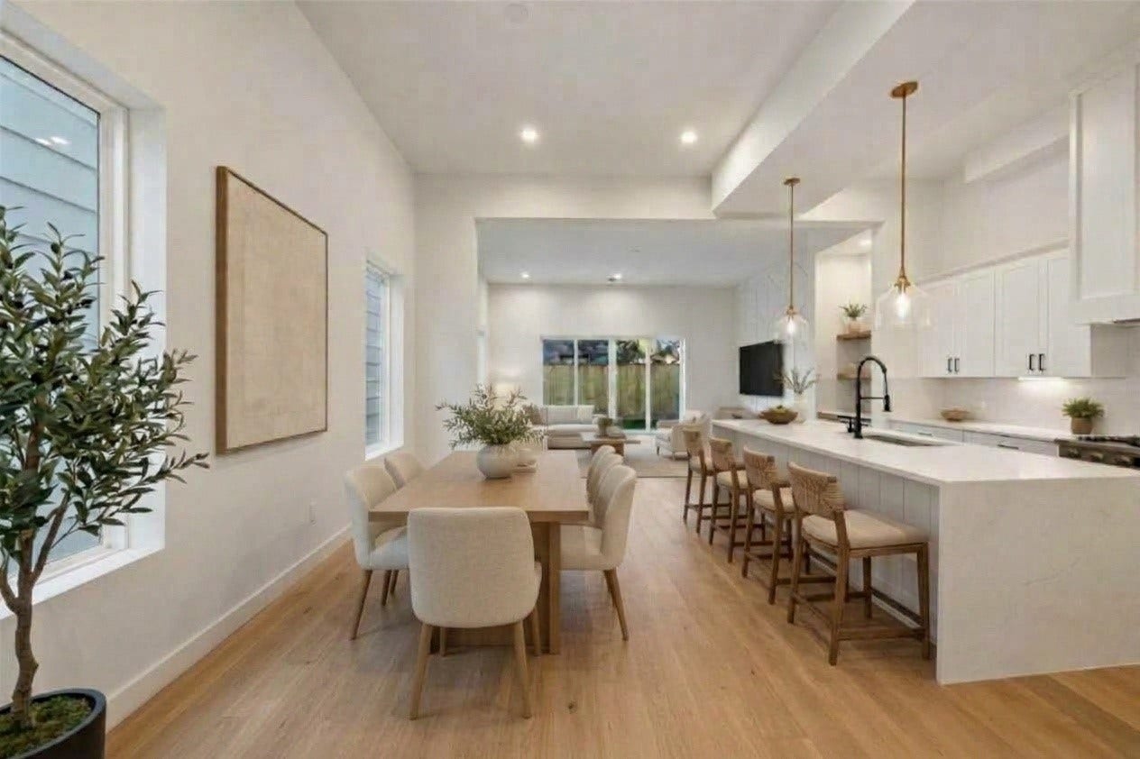 1322 Lawrence Street, Houston, TX 77008 Spacious open dining area paired with a sleek kitchen island and built-in bar seatingperfect for hosting and everyday living