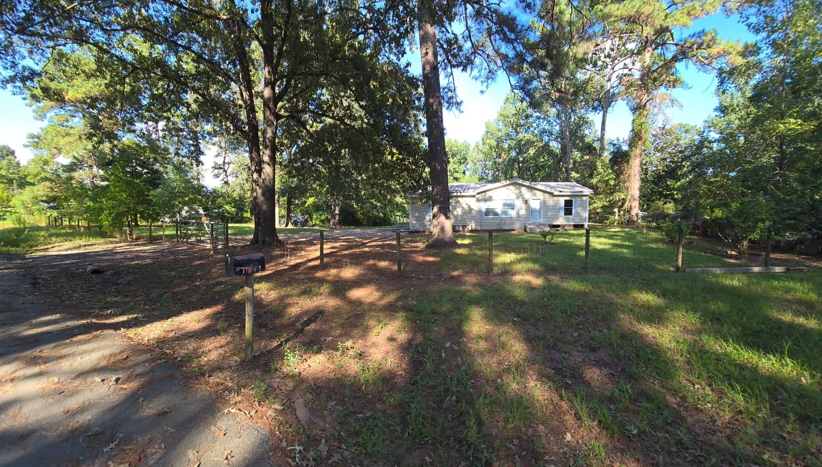 Charming home nestled among mature trees, offering a serene and spacious yard perfect for privacy and outdoor enjoyment.