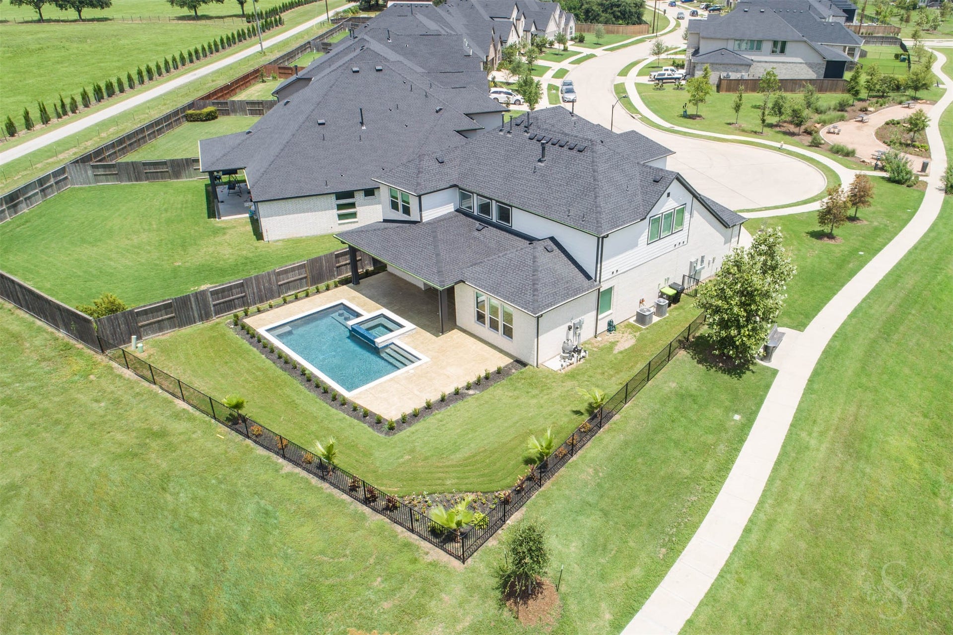 Aerial perspective of the home, pool and oversized homesite.