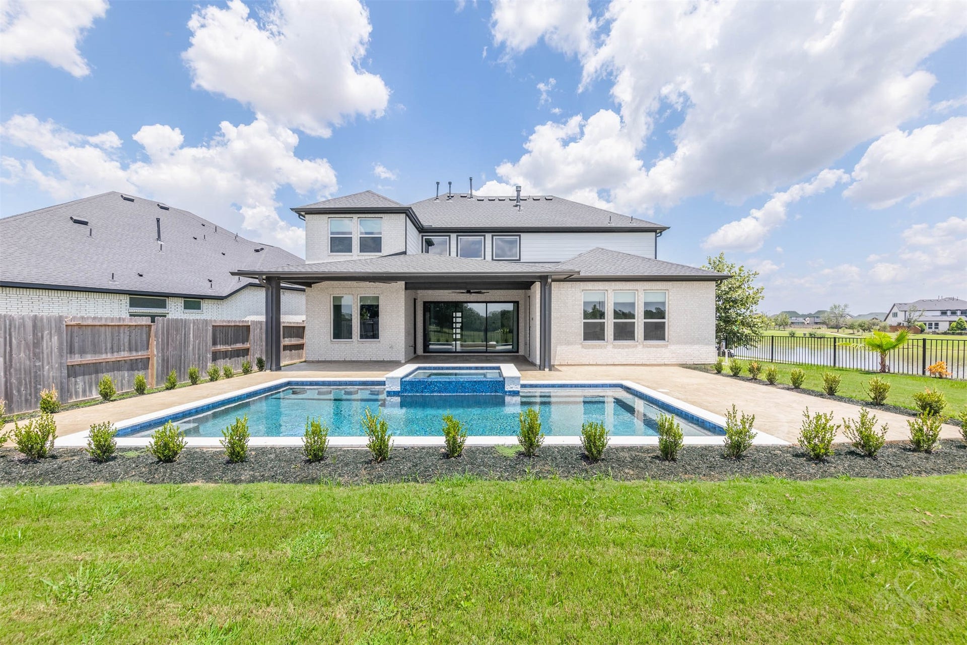 Resort-style backyard with pool, spa and lake views.