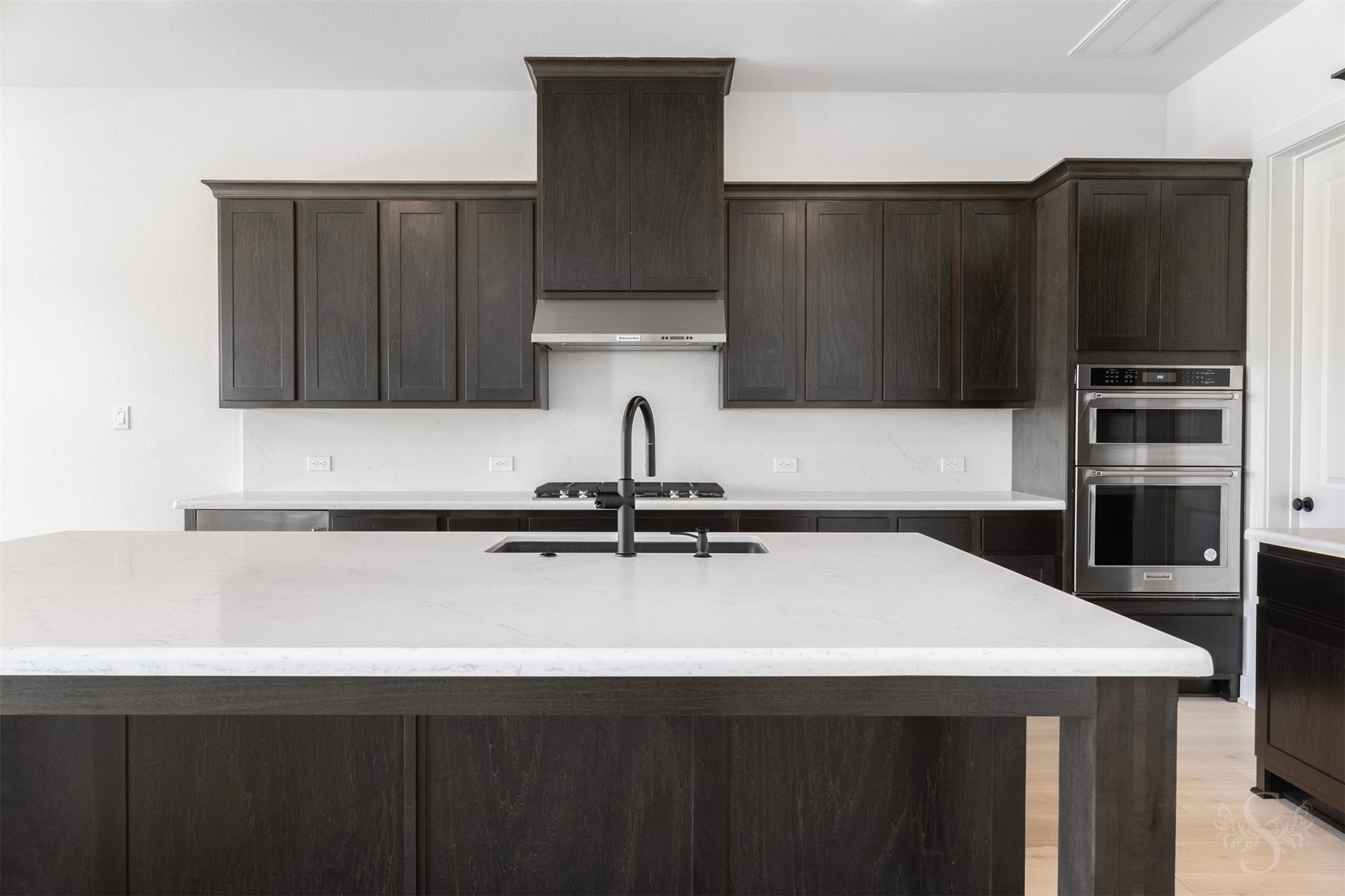 Gourmet kitchen with oversized island and quartz countertops.