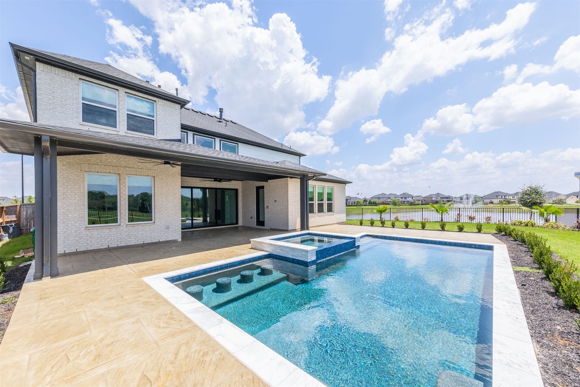 Beautiful pool surrounded by a spacious backyard retreat.