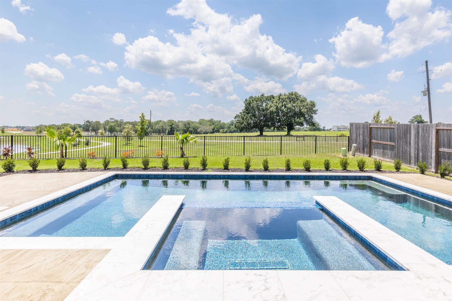 Sparkling pool and spa with beautiful waterfront views.