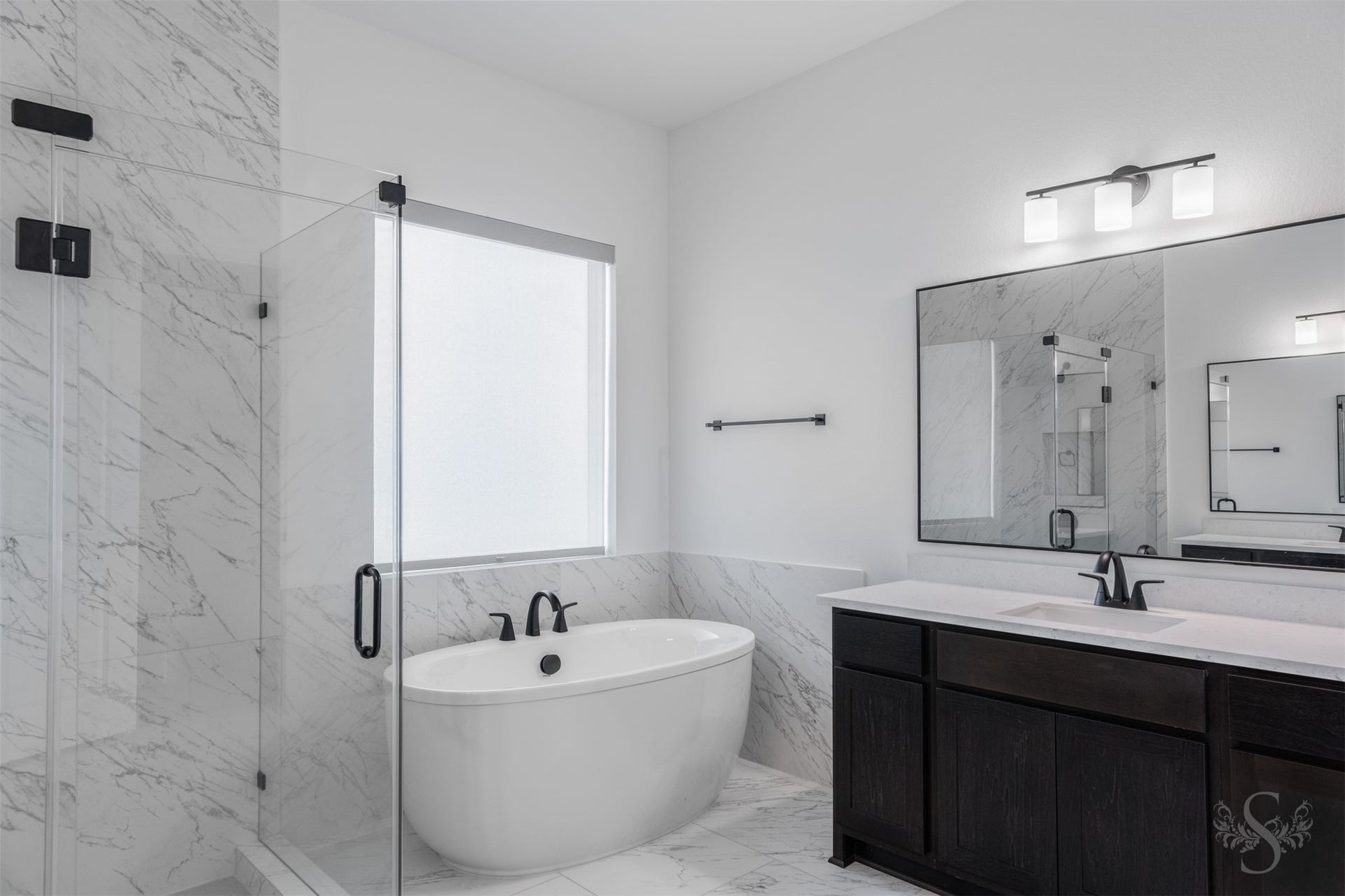 Relaxing soaking tub and beautifully appointed vanity.