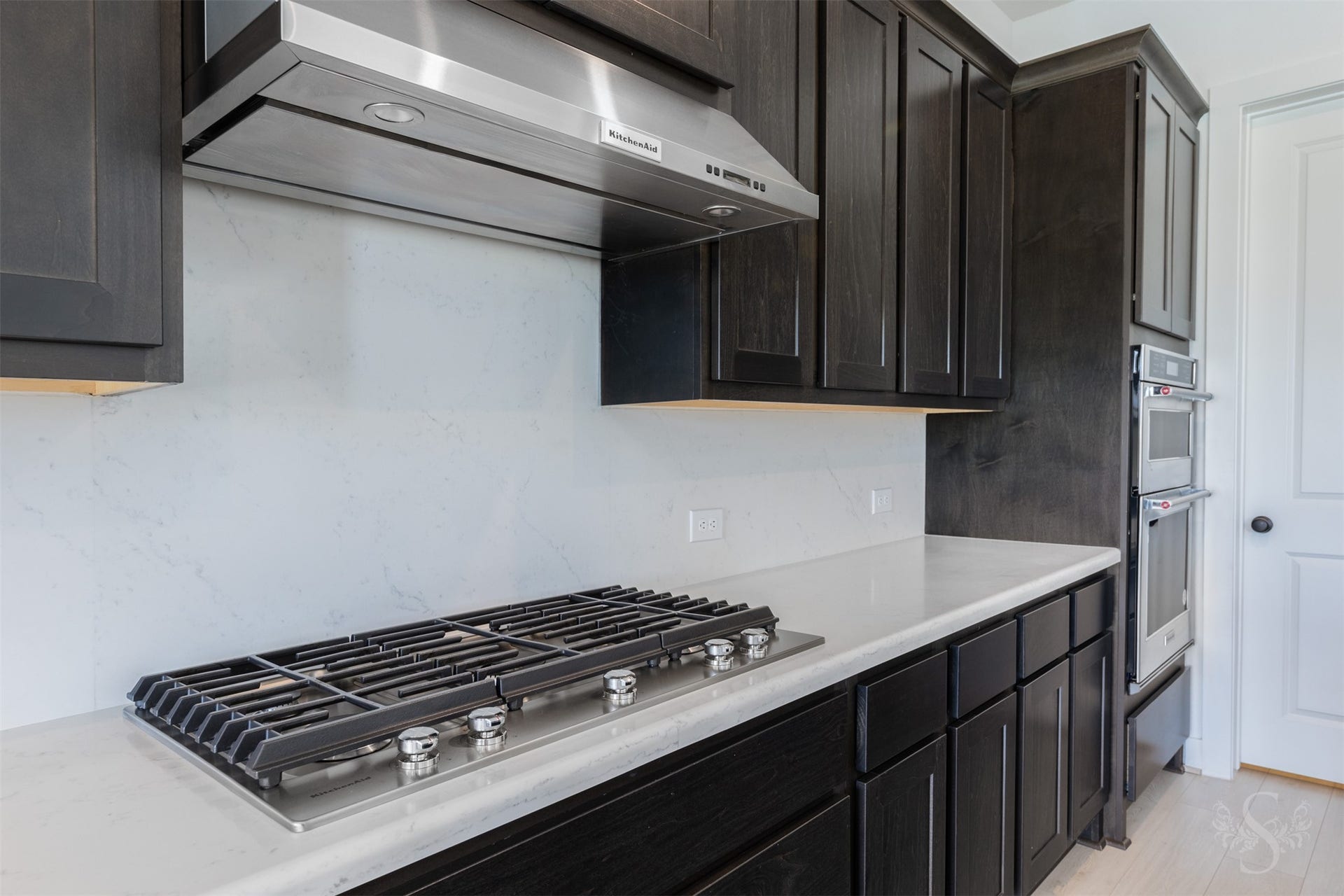 Gas cooktop and generous preparation space.