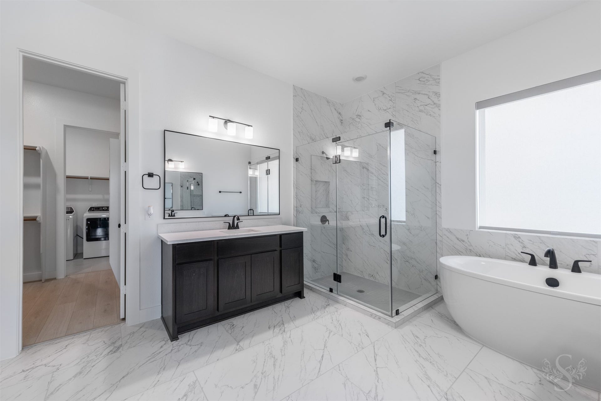Elegant primary bath with dual vanities.