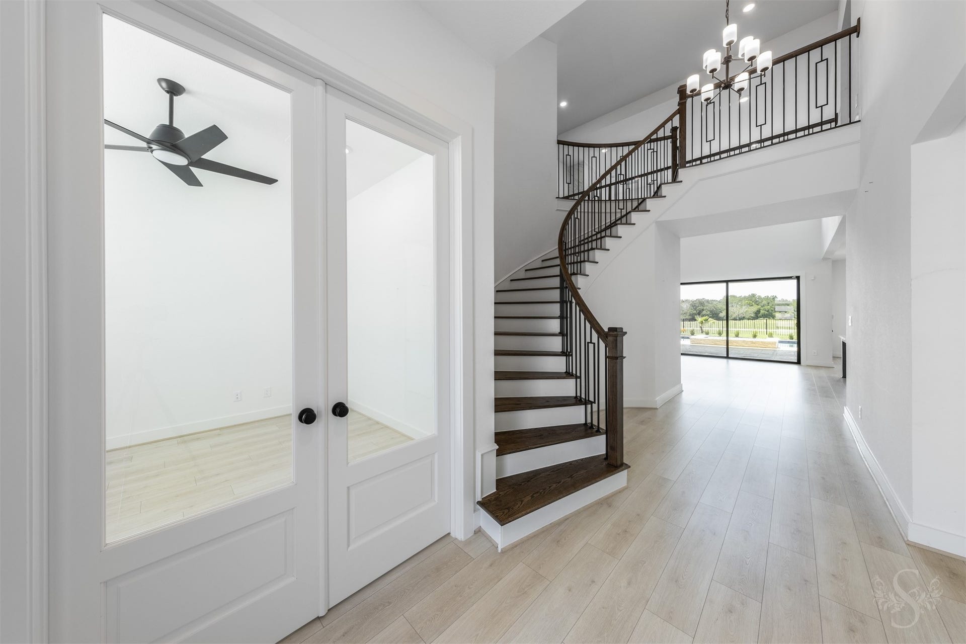 Elegant entry with striking architectural staircase.