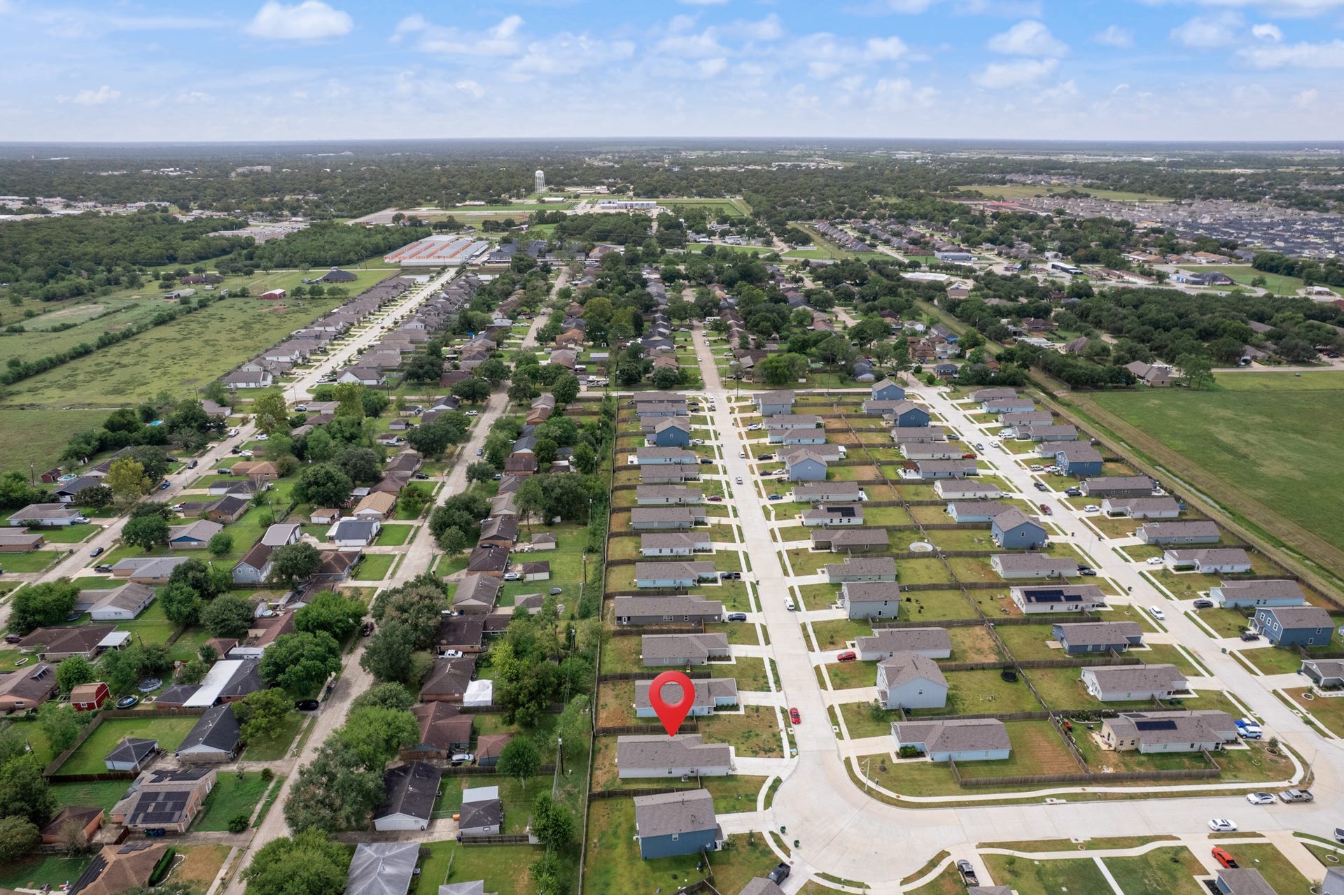 Expansive aerial perspective highlights the homes location within the neighborhood and the surrounding residential landscape.