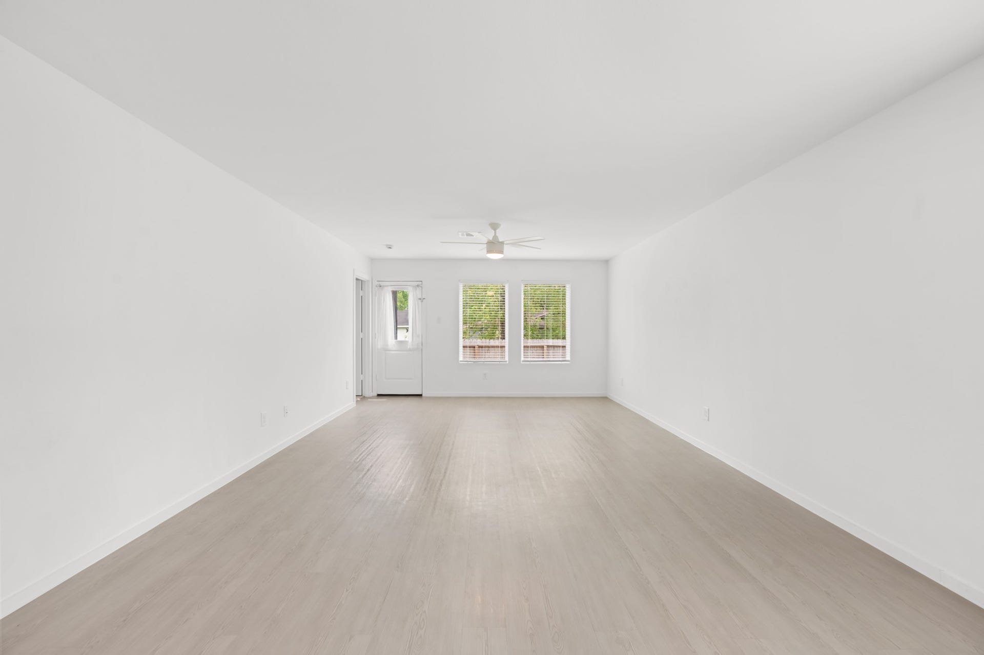 A centered view highlights the generous proportions of the living room, offering plenty of flexibility for seating, media, and entertaining arrangements.