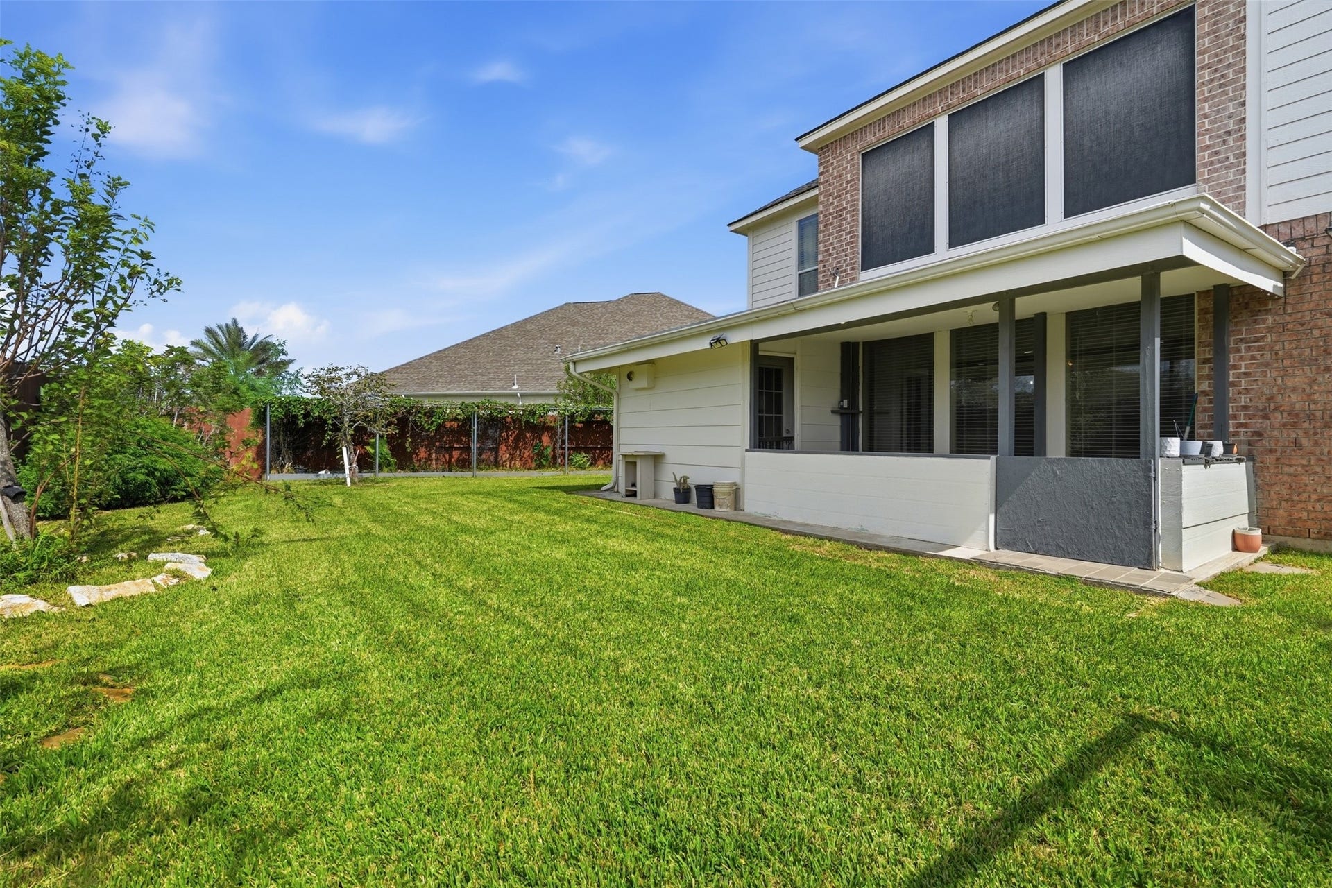 5106 Autumn Rose Lane, Sugar Land, TX 77479 A big private backyard with mature landscaping, plenty of lawn to play, garden or entertain, and sprinklers to keep it green.