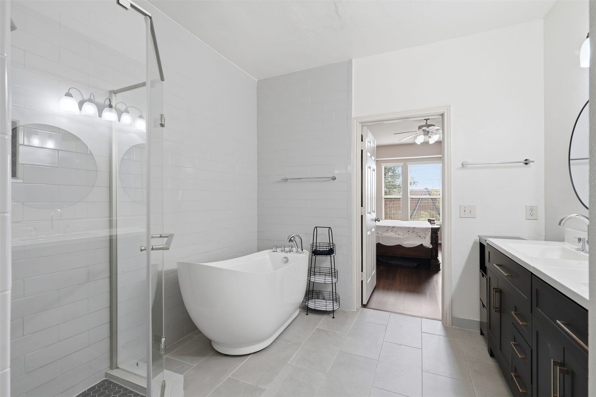 5106 Autumn Rose Lane, Sugar Land, TX 77479 Bright tile, a freestanding tub for slow evenings and a walk-in glass shower for busy mornings. A bath that is fully updated and ready to enjoy.