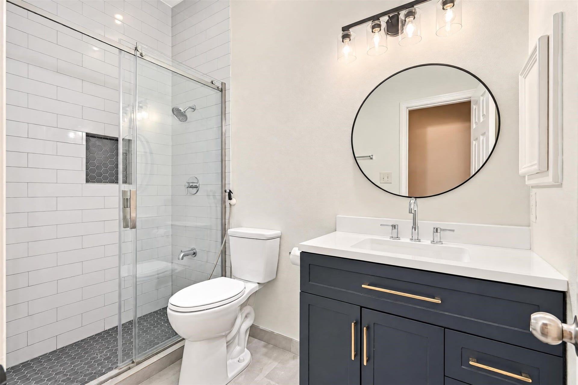 5106 Autumn Rose Lane, Sugar Land, TX 77479 Updated bathroom with a subway-tile walk-in shower behind clear glass and a clean modern vanity.