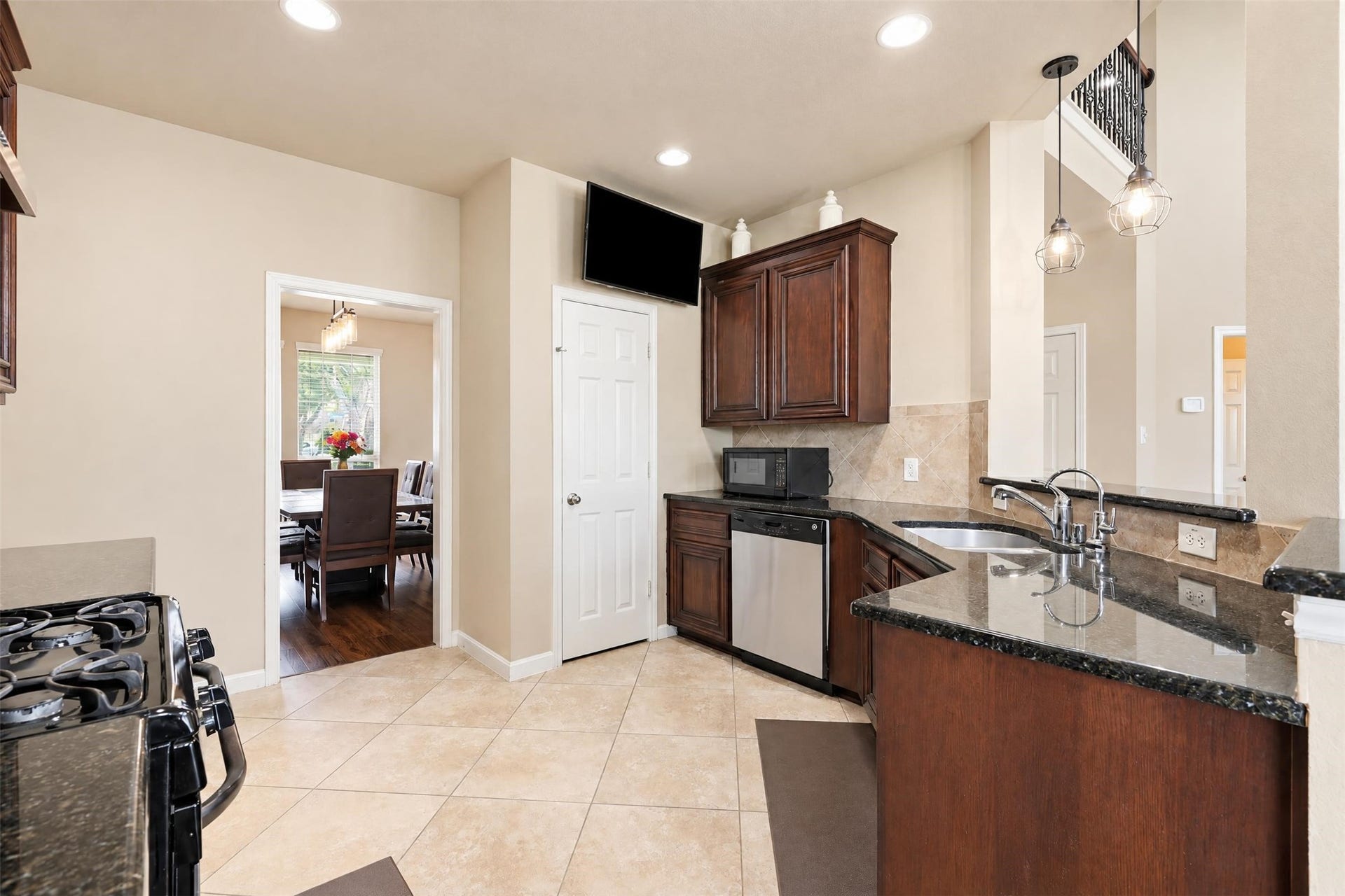 5106 Autumn Rose Lane, Sugar Land, TX 77479 Plenty of cabinet and counter space for meal prep and storage, with a direct path to the formal dining room for easy serving.