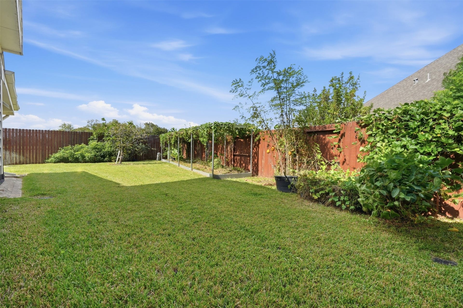 5106 Autumn Rose Lane, Sugar Land, TX 77479 Room for a play set, garden beds or a future pool, with the rear of the home showing its well-kept brick exterior.