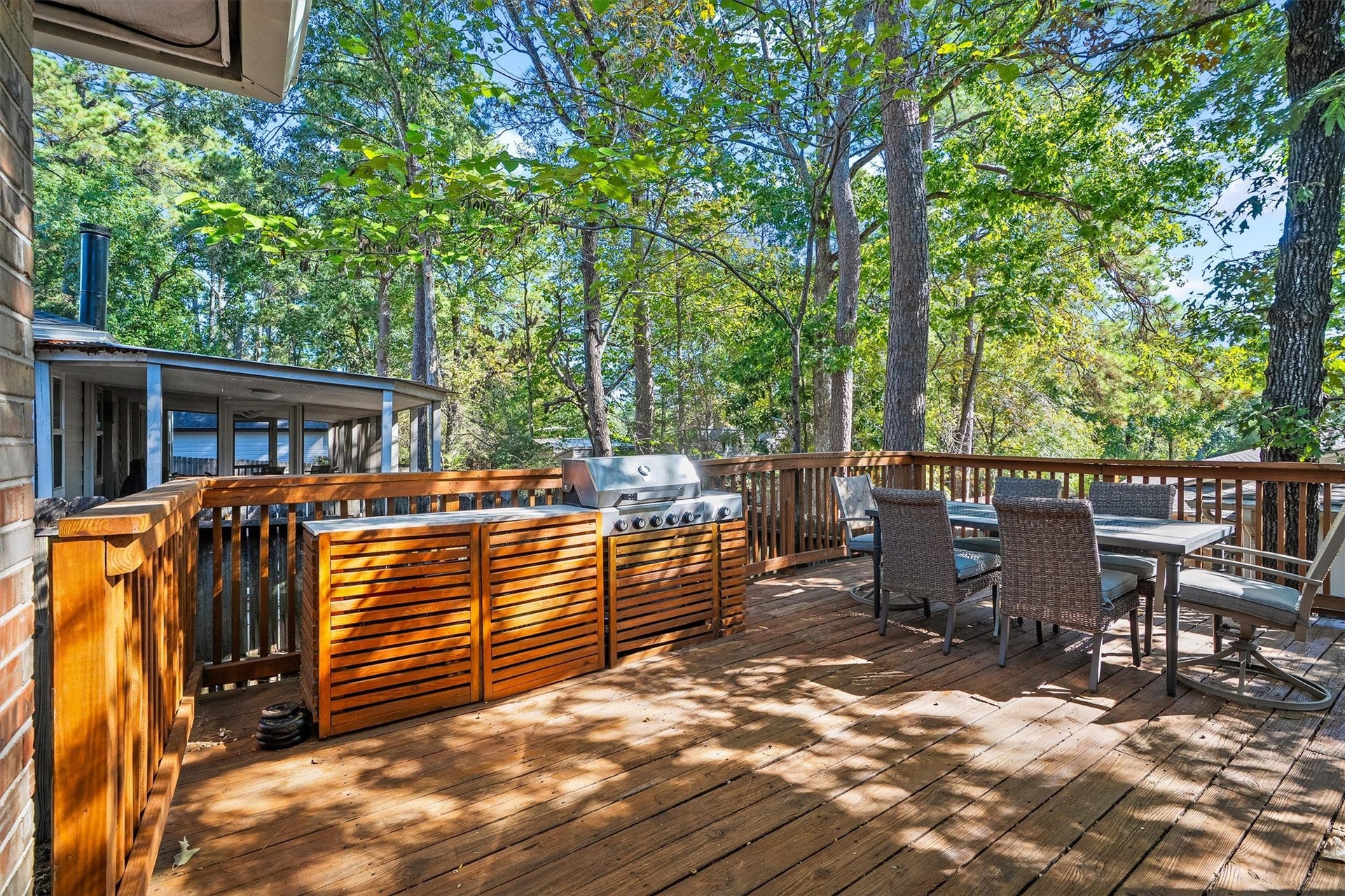 149 Thunderbird Drive, Conroe, TX 77304 The built-in grill station with wood slat cabinetry makes this deck the go-to spot for weekend cookouts, with an exterior gas connection already in place.