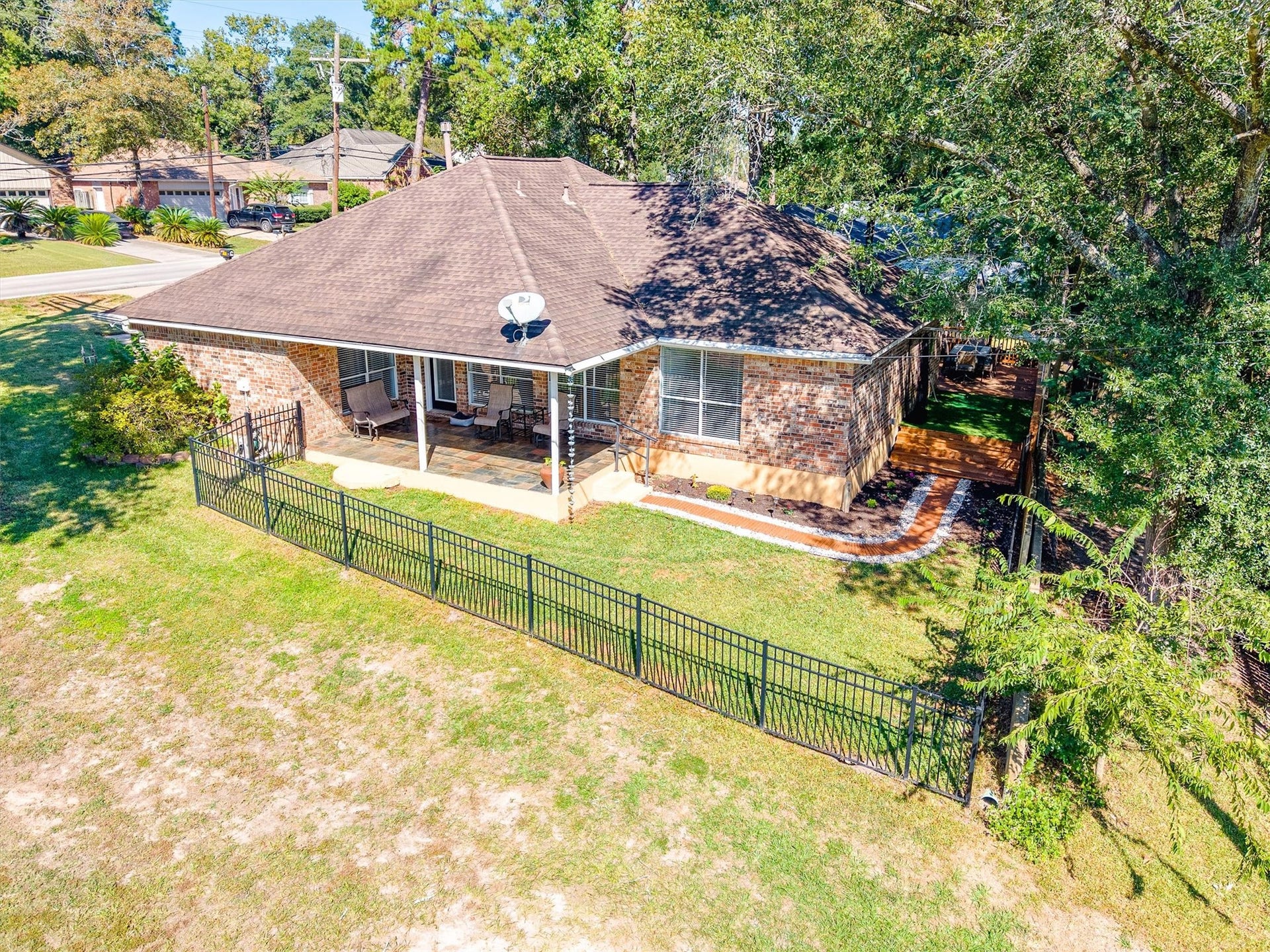 149 Thunderbird Drive, Conroe, TX 77304 From above, you can see how the home sits right on the course, with a black iron fence lining the yard so the fairway view stays open while the backyard stays yours.