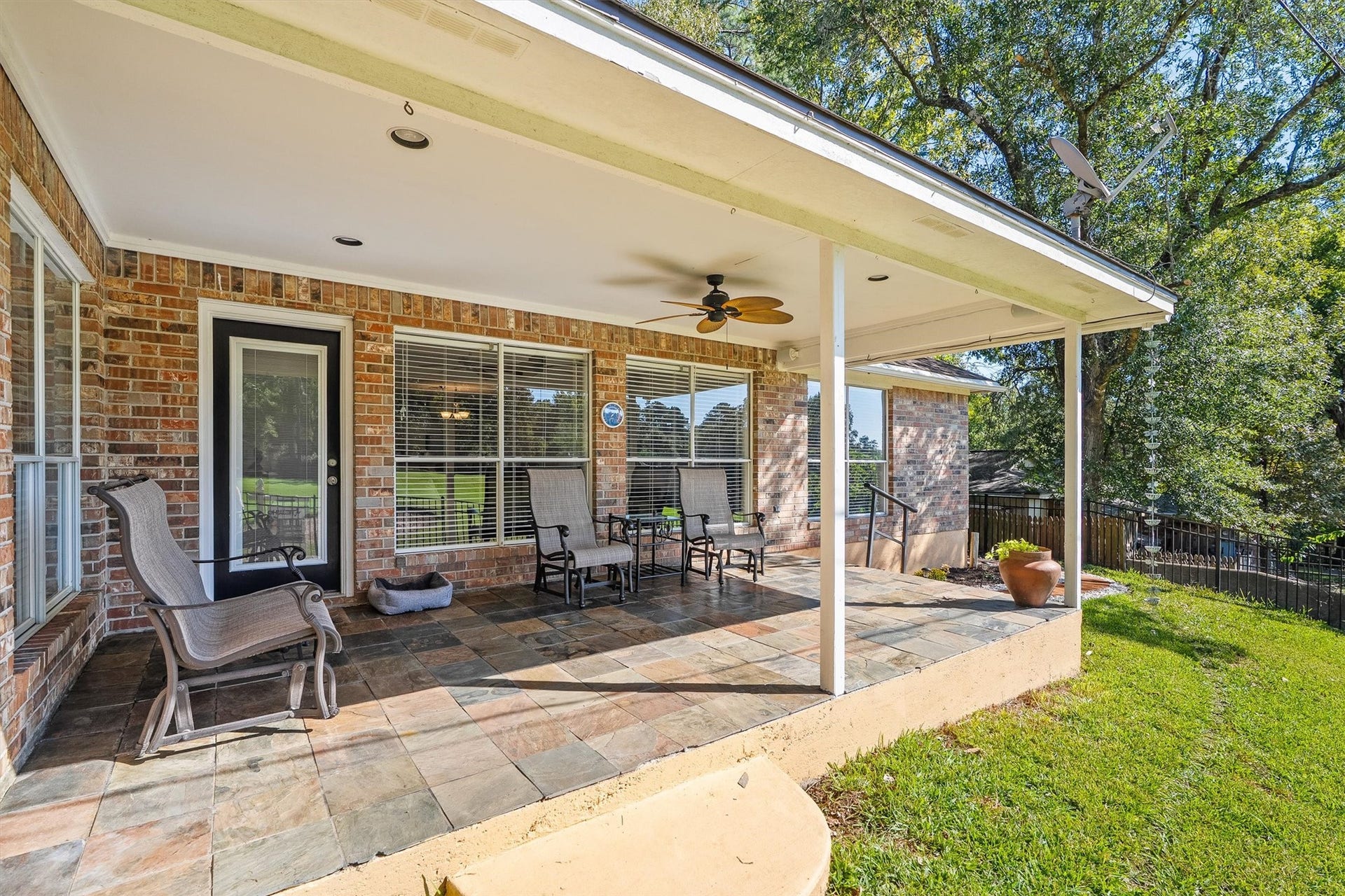 149 Thunderbird Drive, Conroe, TX 77304 Up close, the covered patio shows off its stone tile flooring and recessed lighting, so morning coffee easily turns into an evening hangout.