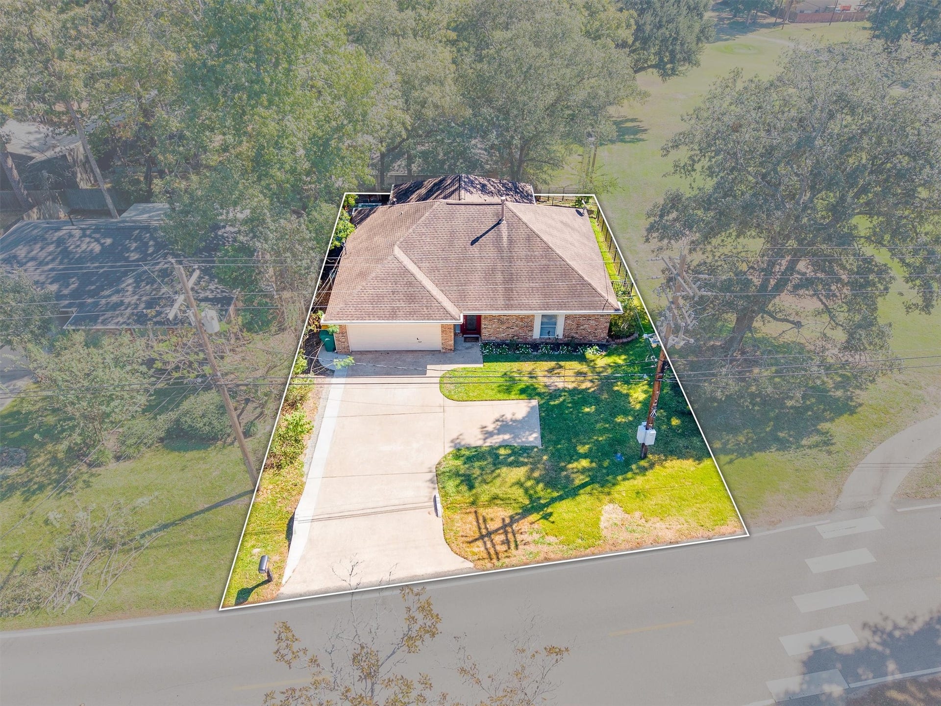 149 Thunderbird Drive, Conroe, TX 77304 From above, you can see the full lot, from the widened driveway out front to the course sitting right alongside.
