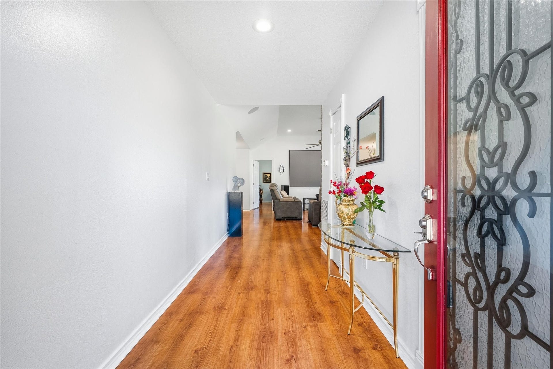 149 Thunderbird Drive, Conroe, TX 77304 The foyer sets the tone with warm wood-look laminate floors and bright white walls that lead you straight back toward the main living space.