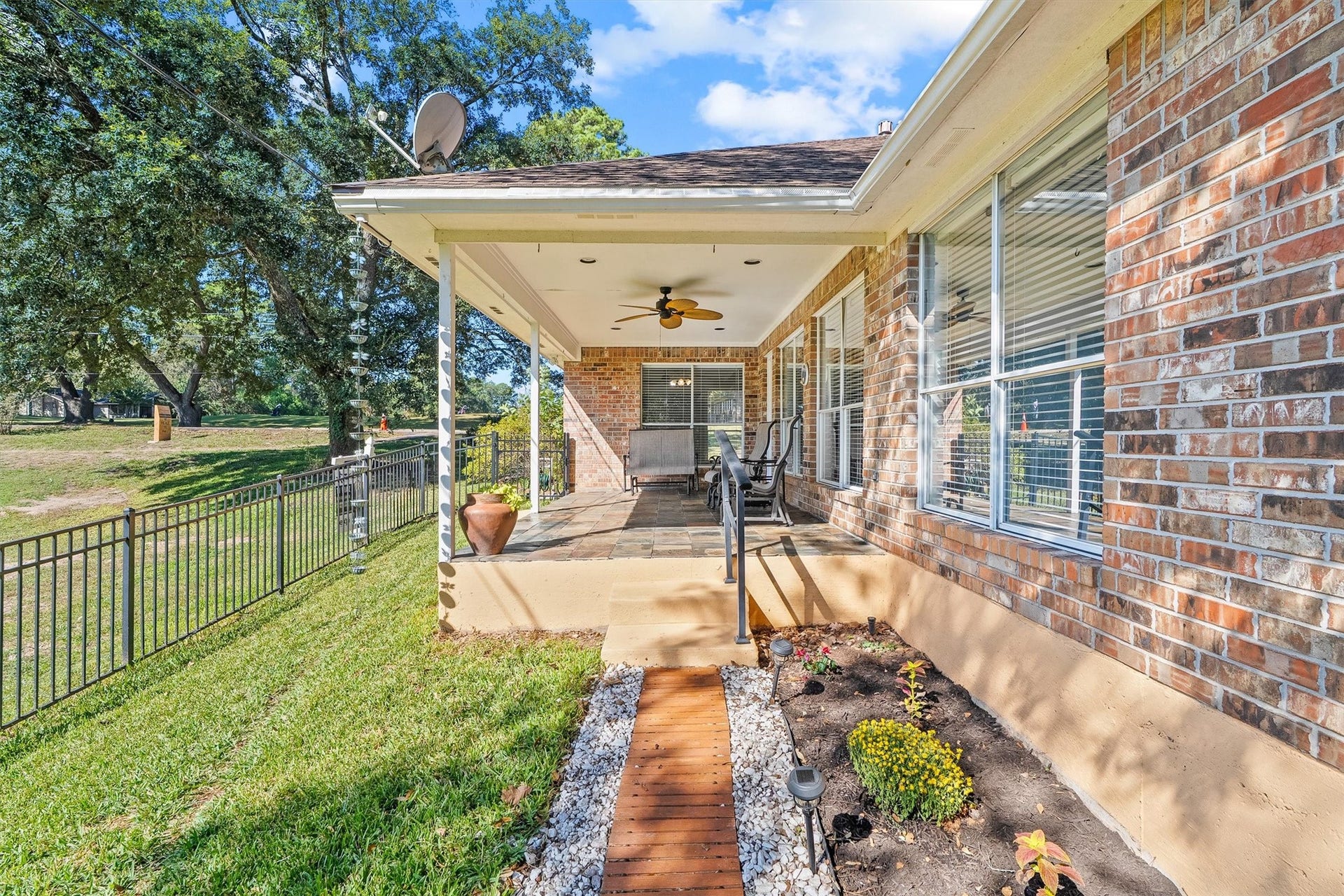 149 Thunderbird Drive, Conroe, TX 77304 A handrail at the patio edge and path lights along the garden bed make getting in and out of the backyard easy, day or night.