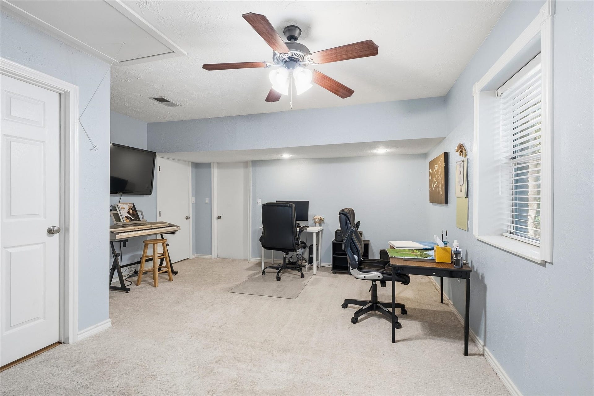 149 Thunderbird Drive, Conroe, TX 77304 Once part of the original garage, this flex room now has space for a home office, a music corner, and whatever hobby comes next.