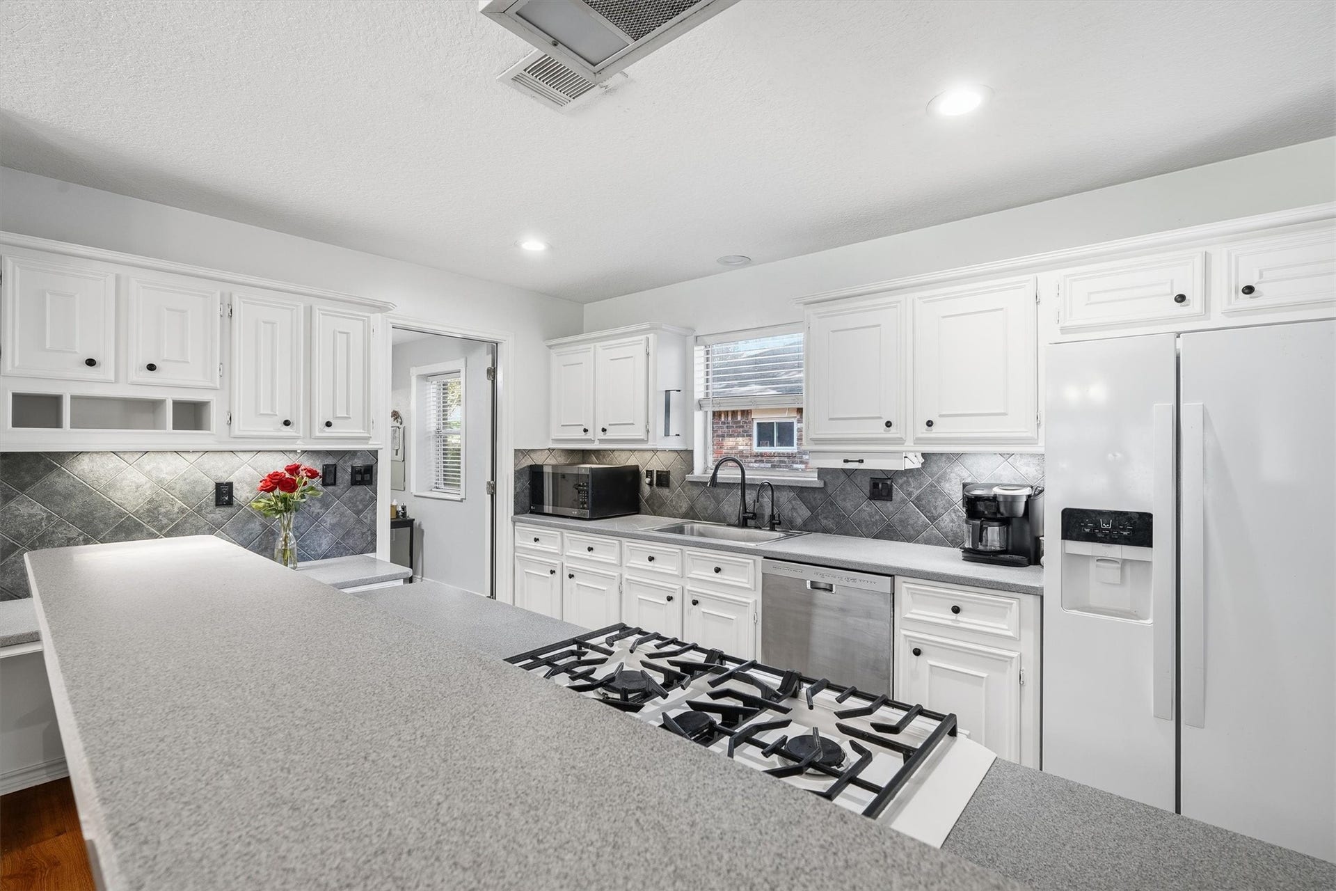 149 Thunderbird Drive, Conroe, TX 77304 Silestone countertops stretch across this kitchen, giving you plenty of room to prep, plate, and still have space for the coffee maker.