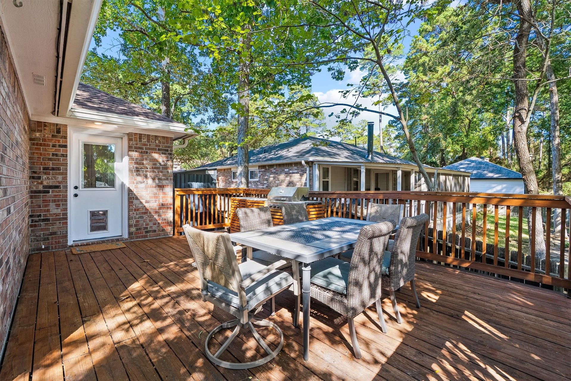 149 Thunderbird Drive, Conroe, TX 77304 The deck connects straight to the kitchen door, which means dinner travels from the counter to the table in seconds.