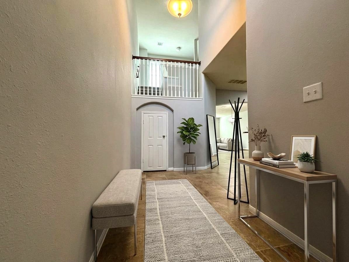 8415 Sunset Loch Drive, Spring, TX 77379 Foyer with under-stairs storage access.