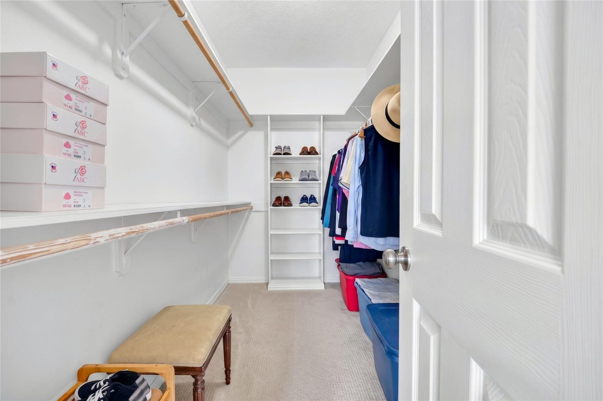 Large walk-in primary closet with generous shelving and hanging space.