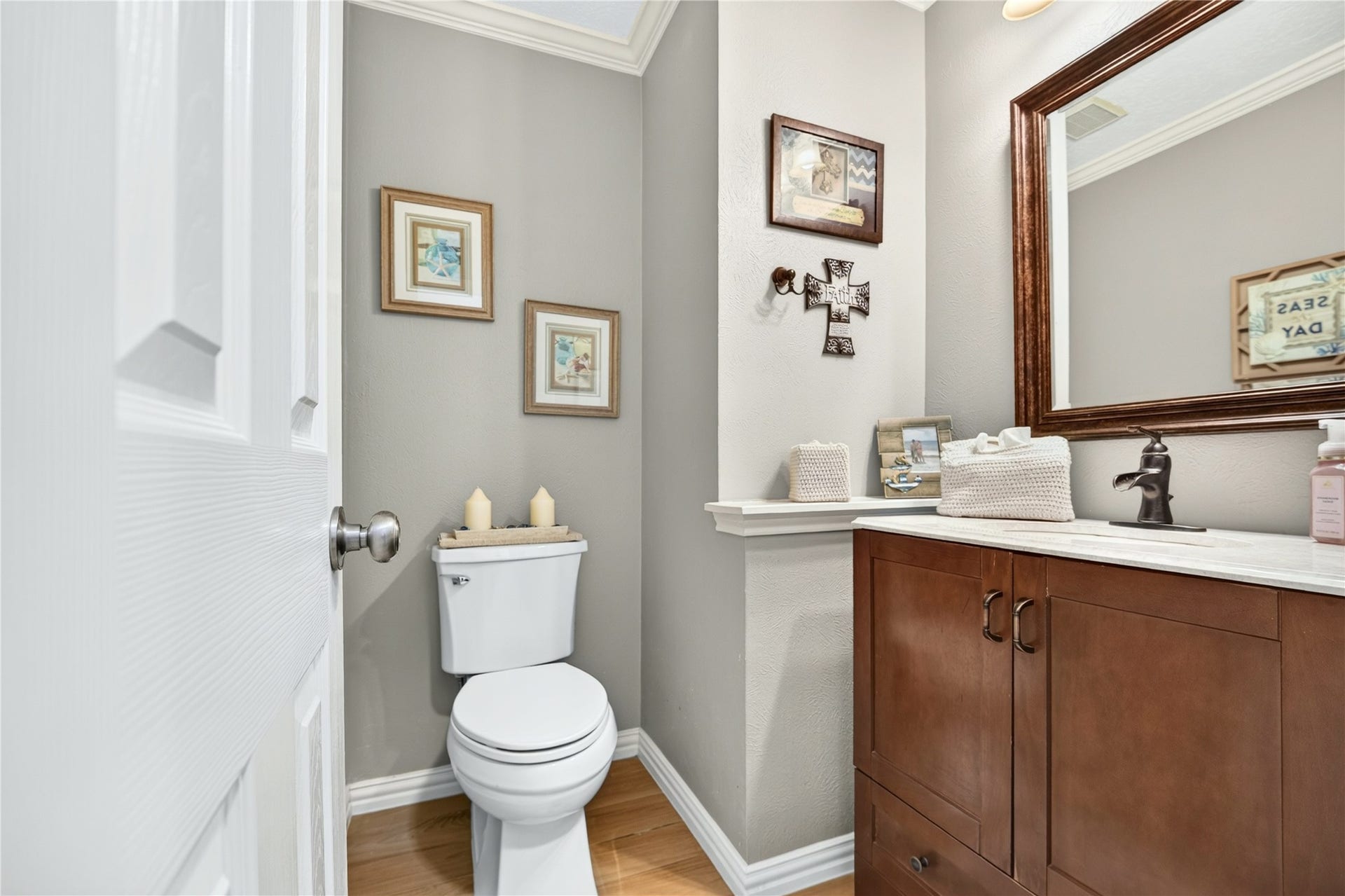 Convenient downstairs half bath with updated vanity and framed mirror.