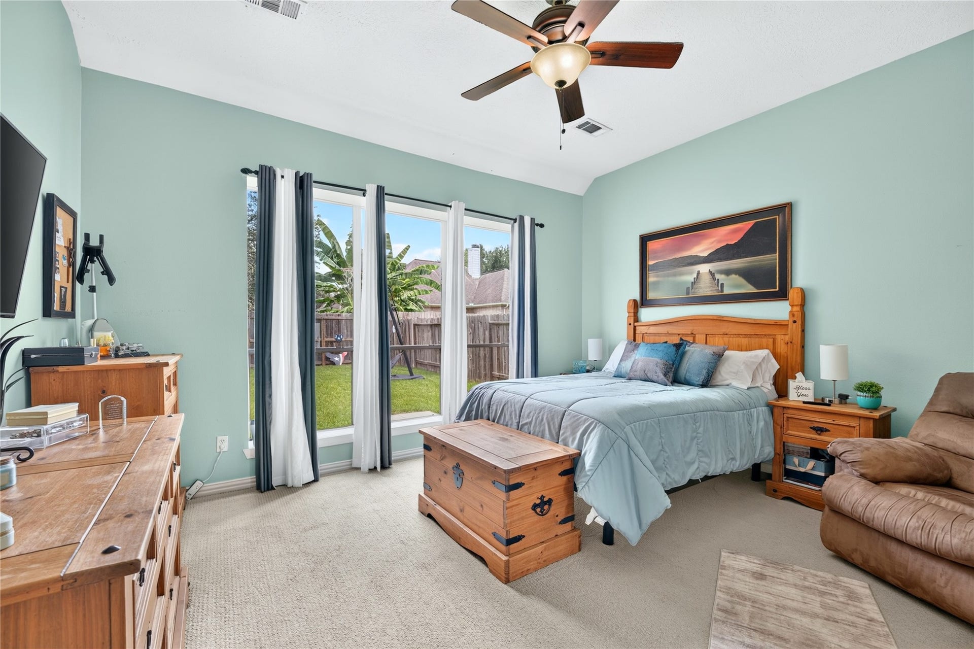 Spacious primary bedroom with high ceilings, large windows and ensuite bath.